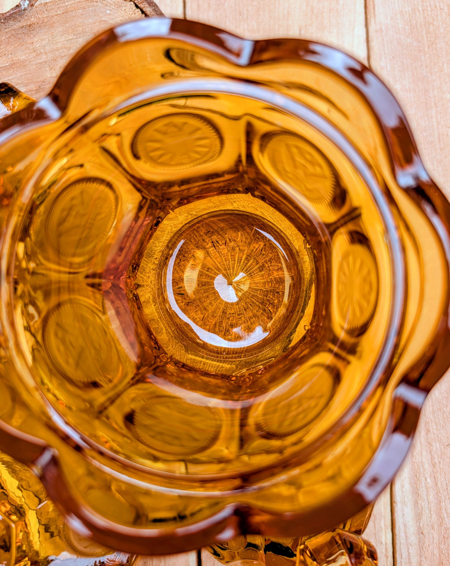 A stunning matching set of vintage Indiana Glass in the iconic Kings Crown (Coin) pattern. This coordinated amber glass collection includes a covered pedestal vase and matching covered candy dish, each with its original lid. A beautiful Mid-Century display for collectors and vintage home décor enthusiasts.
