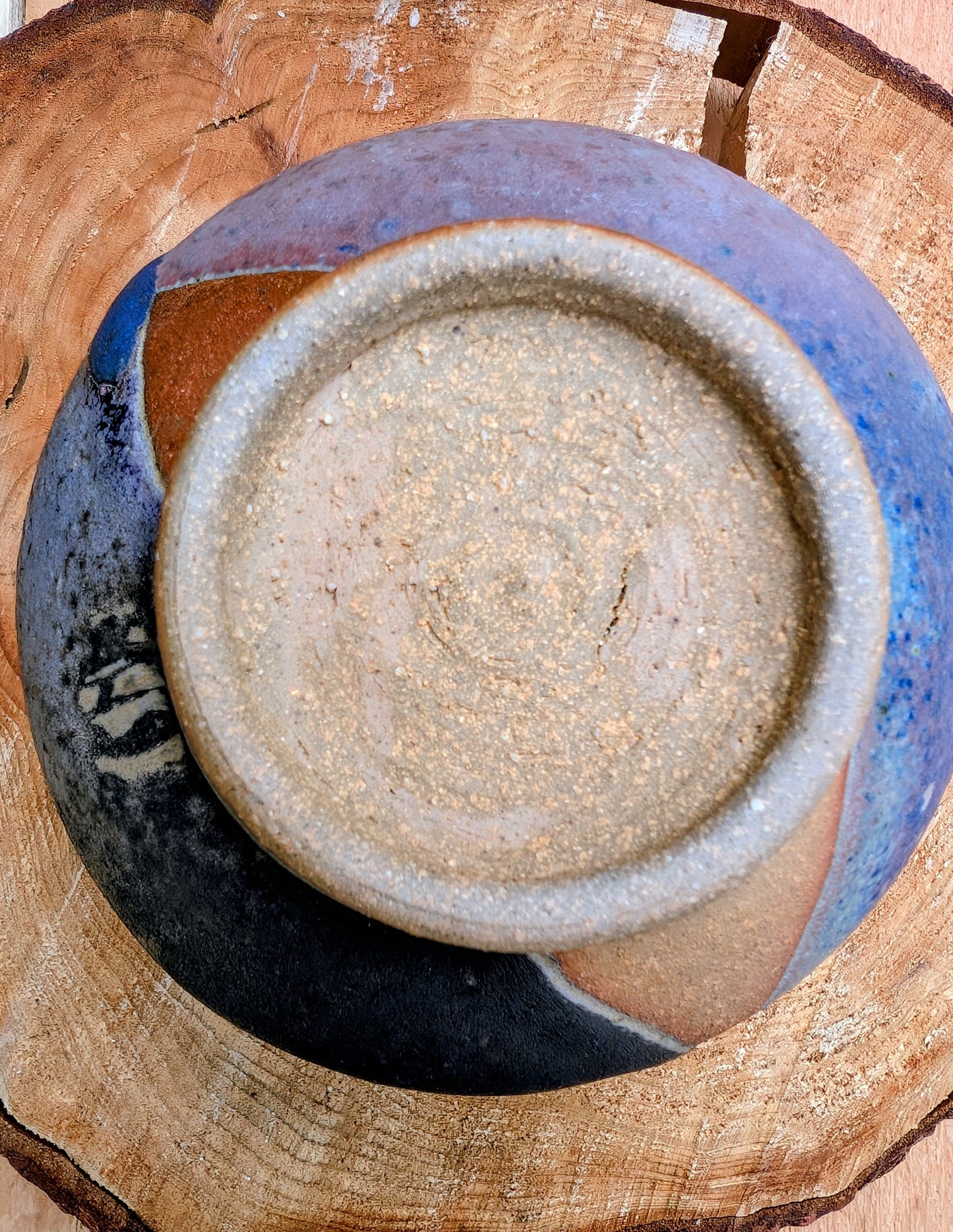 Bring handcrafted artistry to your home with this small footed studio pottery bowl featuring layered reactive glazes in purple, blue, charcoal, and earthy brown. Wheel-thrown from high-fired stoneware, its one-of-a-kind finish makes it equally beautiful as functional tableware or decorative art.