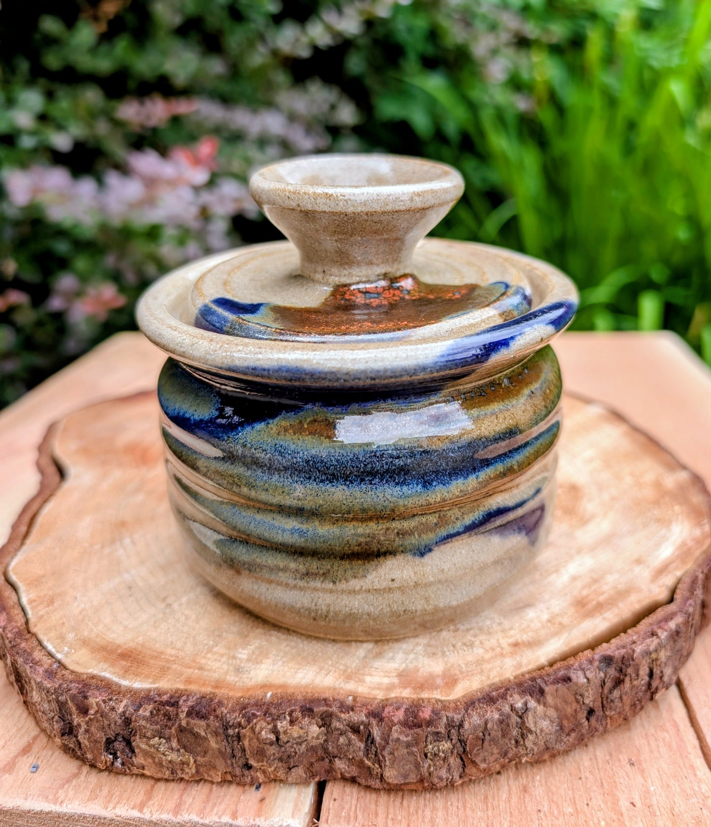 Bring handcrafted warmth to your kitchen with this signed studio pottery lidded jam pot featuring richly layered cobalt blue, olive, brown, and tan glazes. Perfect for serving honey, preserves, sugar, or favorite condiments, this artisan stoneware piece is both beautiful and functional.