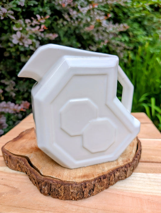 Bring timeless American Art Deco design into your home with this vintage Alamo Pottery Shape No. 758 pitcher. Its crisp geometric silhouette and glossy white glaze make it equally beautiful as a functional pitcher, sculptural vase, or decorative accent.