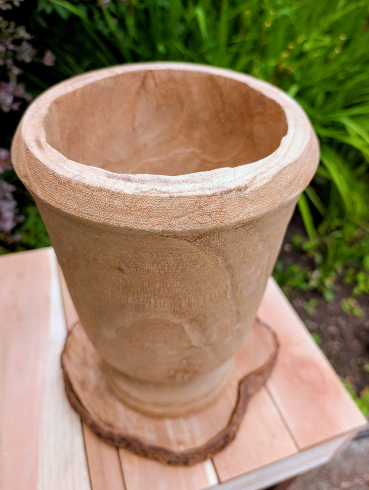 Bring natural warmth and organic texture into your home with this hand-carved paulownia wood footed vase. Its sculptural silhouette and unfinished wood grain make it a timeless accent for dried botanicals, seasonal branches, or as a beautiful standalone decorative piece.