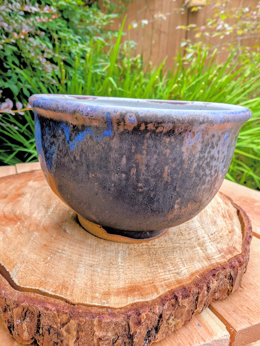 Bring handcrafted artistry to your home with this small footed studio pottery bowl featuring layered reactive glazes in purple, blue, charcoal, and earthy brown. Wheel-thrown from high-fired stoneware, its one-of-a-kind finish makes it equally beautiful as functional tableware or decorative art.