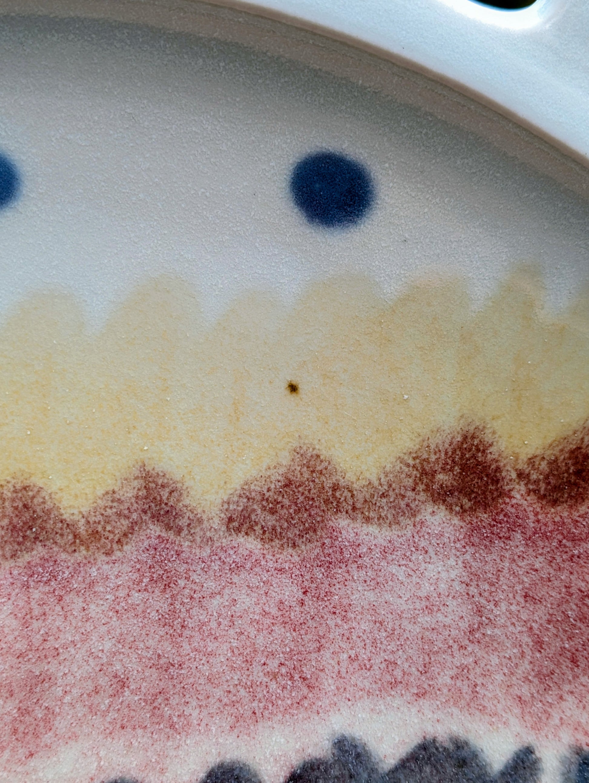 A beautifully handcrafted 14-inch studio pottery platter featuring layered abstract decoration in soft blue-gray, dusty pink, cream, and cobalt accents. Equally stunning as a serving piece or decorative display charger, this artisan-made platter brings timeless craftsmanship to modern living.