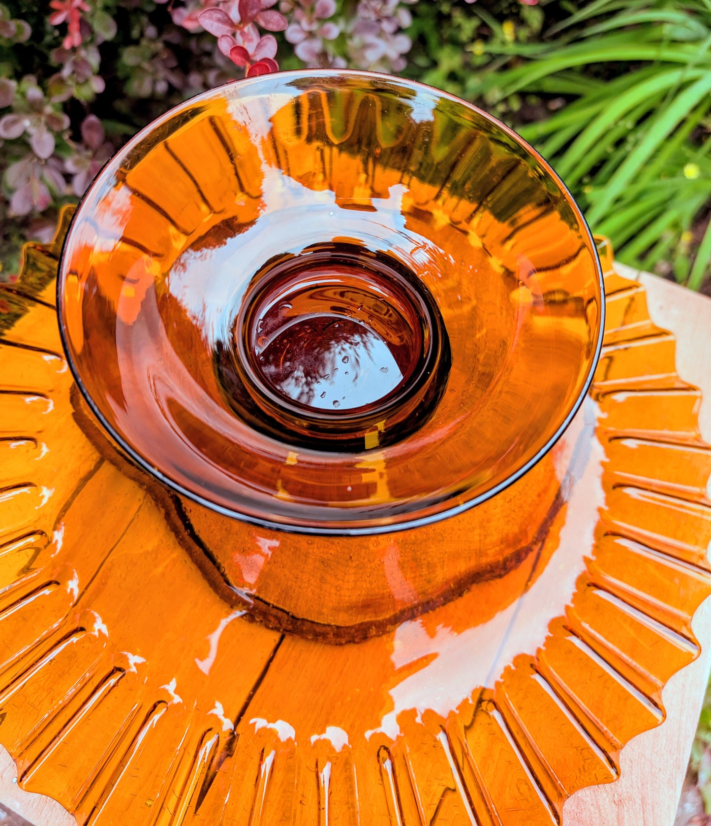 Bring warm vintage charm to your home with this large amber pressed glass pedestal console bowl, estimated to have been made by Indiana Glass during the 1960s–1970s. Its dramatic ruffled rim and generous size make it a beautiful centerpiece for seasonal displays, fruit, florals, or decorative accents throughout the year.