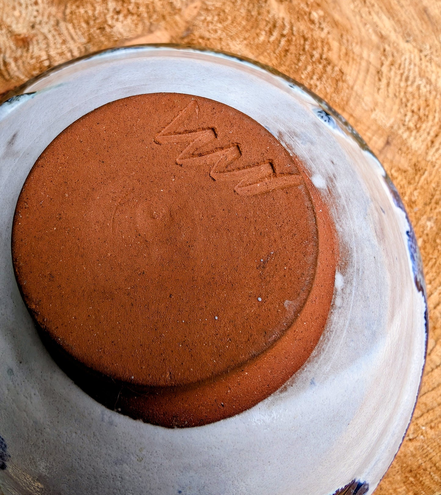 Bring handcrafted artistry to your table with this matching pair of signed studio pottery bowls. Finished with richly layered reactive glazes in cobalt blue, teal, amber, and ivory, these versatile artisan bowls are equally beautiful for entertaining or everyday display.