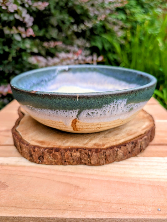 A beautifully handcrafted studio pottery bowl signed by Steve & Johnna and dated 1993. Featuring layered forest green, lavender-blue, and cream glazes, this wheel-thrown stoneware piece embodies the timeless beauty of American studio ceramics and is equally suited for everyday use or display.