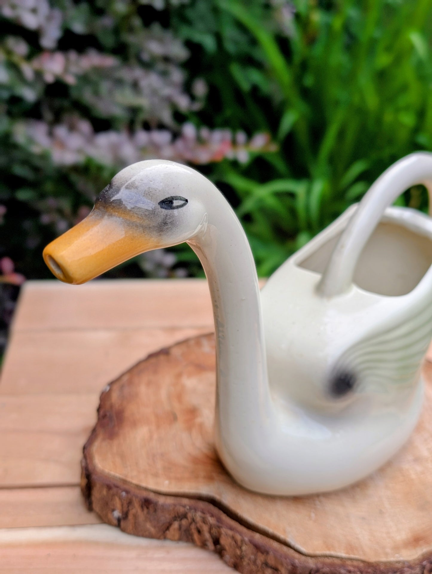 A charming 1950s Nouvelle Pottery swan watering pitcher that blends sculptural beauty with everyday function. Finished in a soft ivory glaze with hand-painted details, this Mid-Century ceramic piece is equally at home caring for houseplants or displayed as timeless vintage décor.