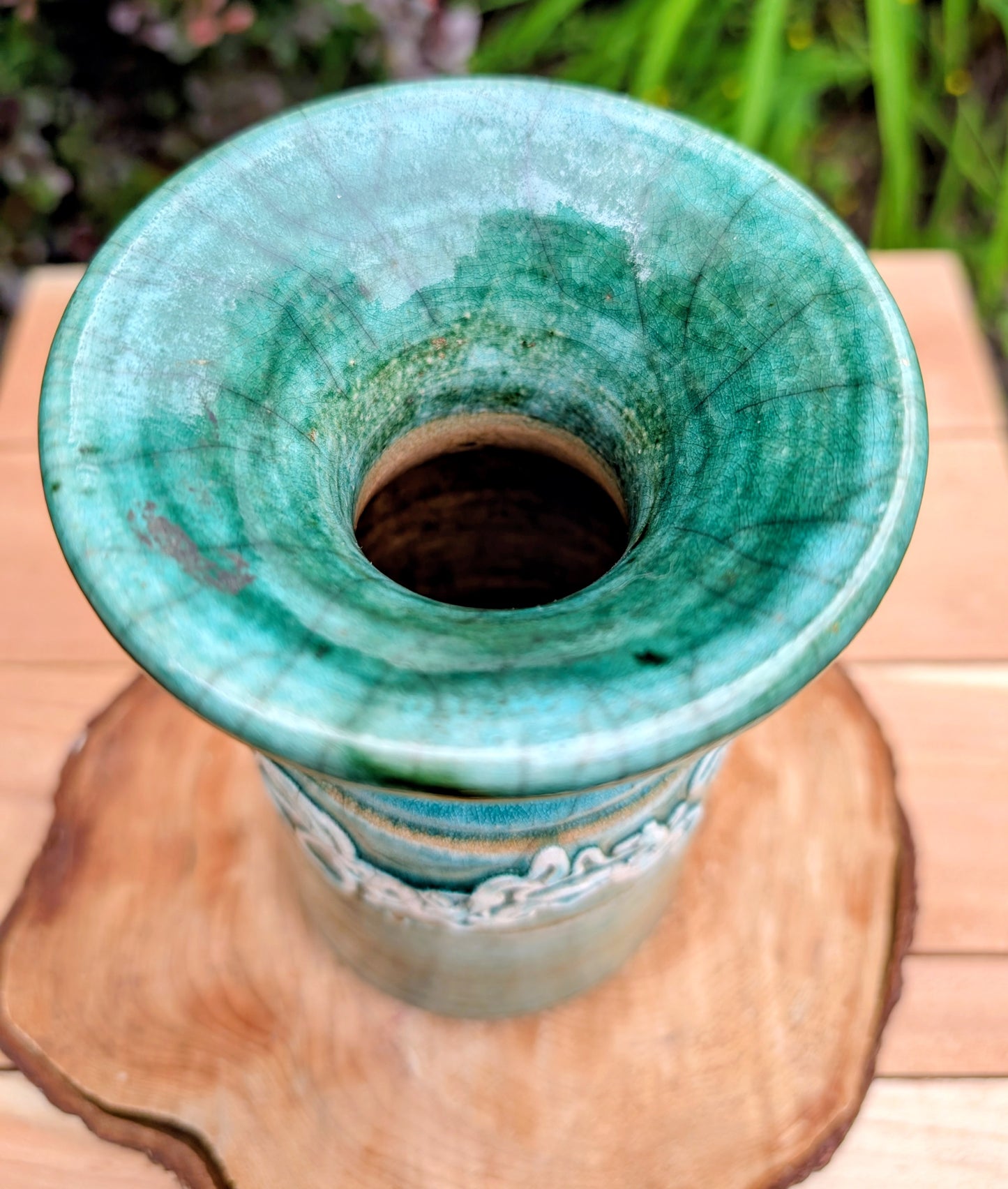 Celebrate the artistry of 1970s studio ceramics with this signed and dated handmade stoneware vase. Finished in a rich teal crackle glaze with distinctive white applied slip decoration, this sculptural piece brings timeless character to shelves, tables, and curated collections.