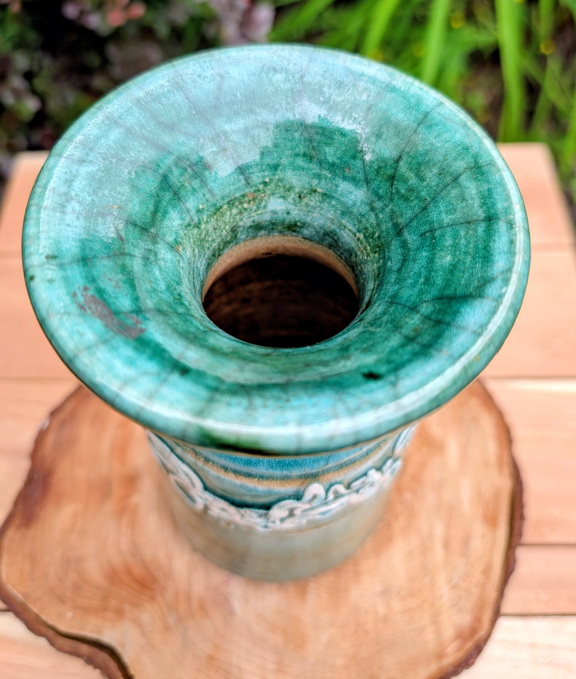 Celebrate the artistry of 1970s studio ceramics with this signed and dated handmade stoneware vase. Finished in a rich teal crackle glaze with distinctive white applied slip decoration, this sculptural piece brings timeless character to shelves, tables, and curated collections.