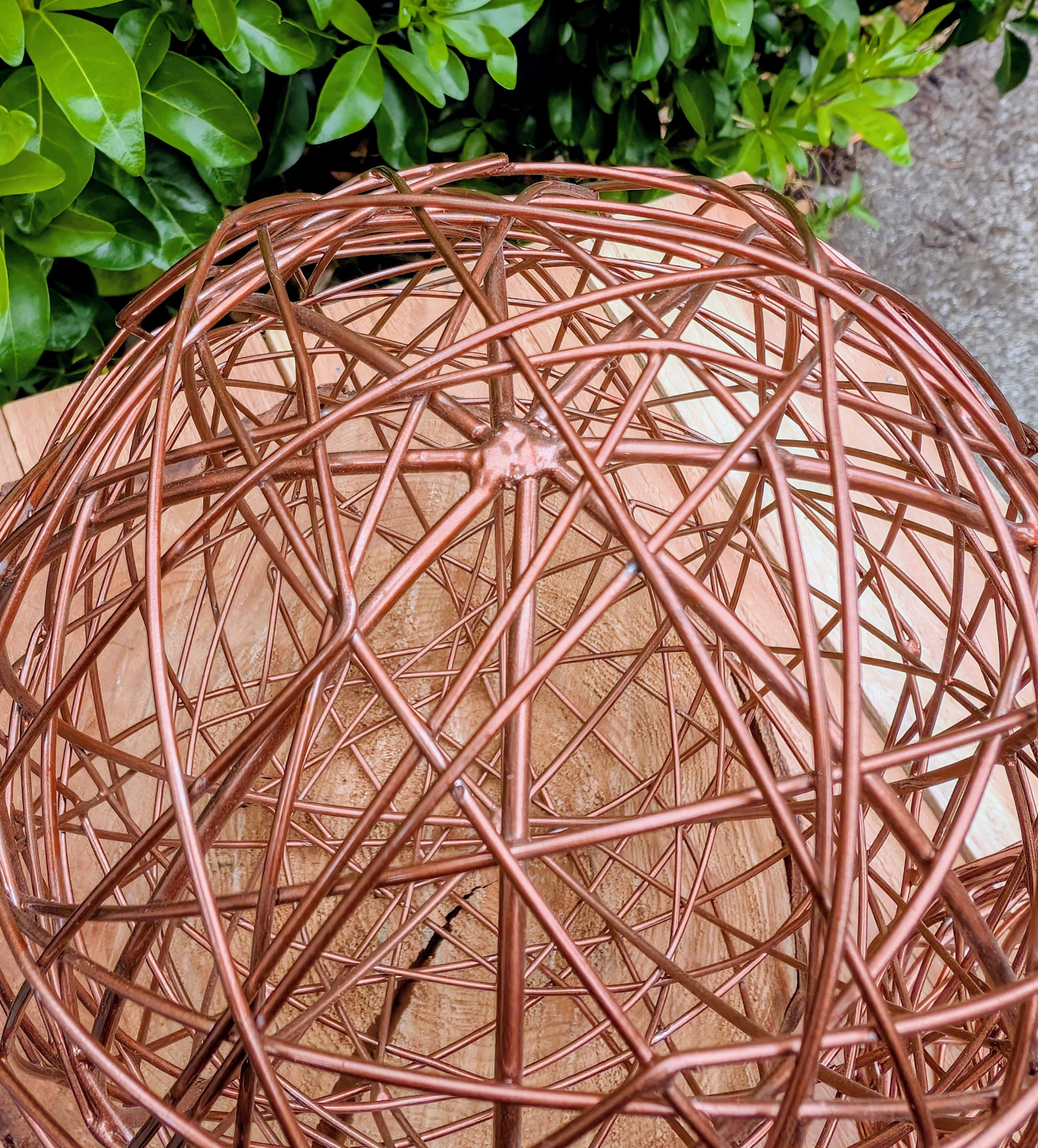 Bring warmth and texture to your home with this coordinated set of two copper-tone woven metal decorative spheres. Their sculptural open-weave design complements modern organic, farmhouse, industrial, and contemporary interiors, making them versatile accents for shelves, coffee tables, decorative bowls, and centerpieces.