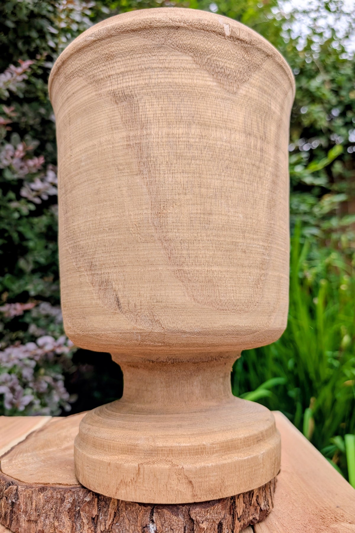 Bring natural warmth and organic texture into your home with this hand-carved paulownia wood footed vase. Its sculptural silhouette and unfinished wood grain make it a timeless accent for dried botanicals, seasonal branches, or as a beautiful standalone decorative piece.