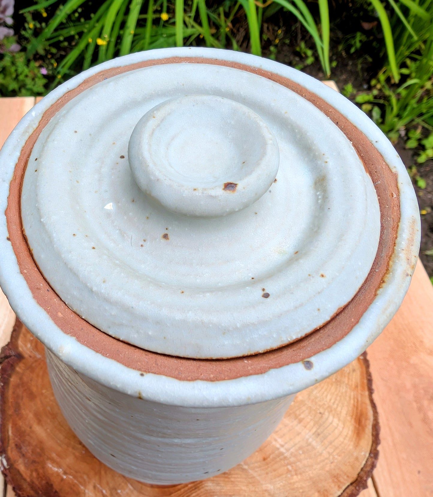 Bring warmth and handcrafted character to your kitchen with this wheel-thrown stoneware canister. Finished in a soft creamy-white glaze with subtle iron speckling, this timeless storage vessel blends rustic craftsmanship with modern organic design.