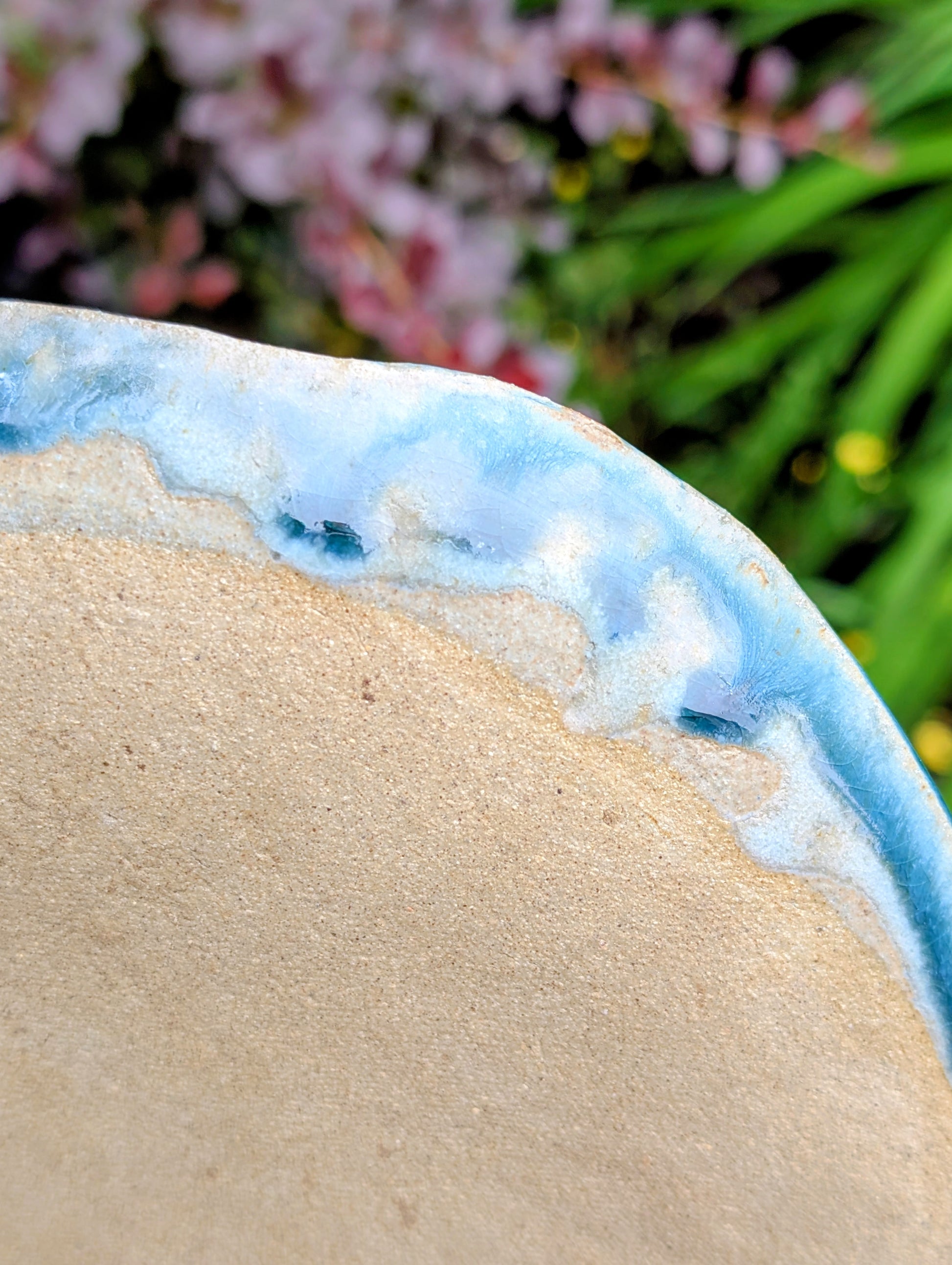 Celebrate the beauty of nature with this signed handbuilt studio pottery platter featuring an elegant botanical relief impressed directly into the clay. Finished in layered blue, teal, and olive glazes, this contemporary stoneware piece is equally at home as functional serveware or displayed as ceramic wall art.