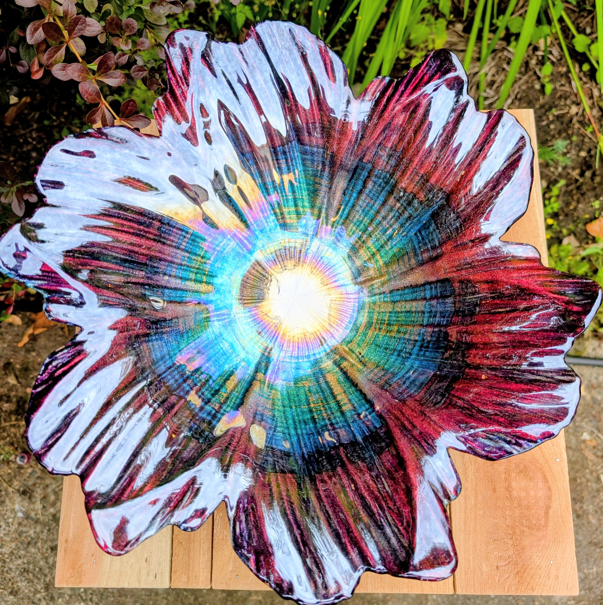 Bring color and artistry to your home or garden with this iridescent art glass floral bowl. Featuring shimmering purple and blue hues, it serves beautifully as either a striking tabletop centerpiece or a decorative bird bath bowl.