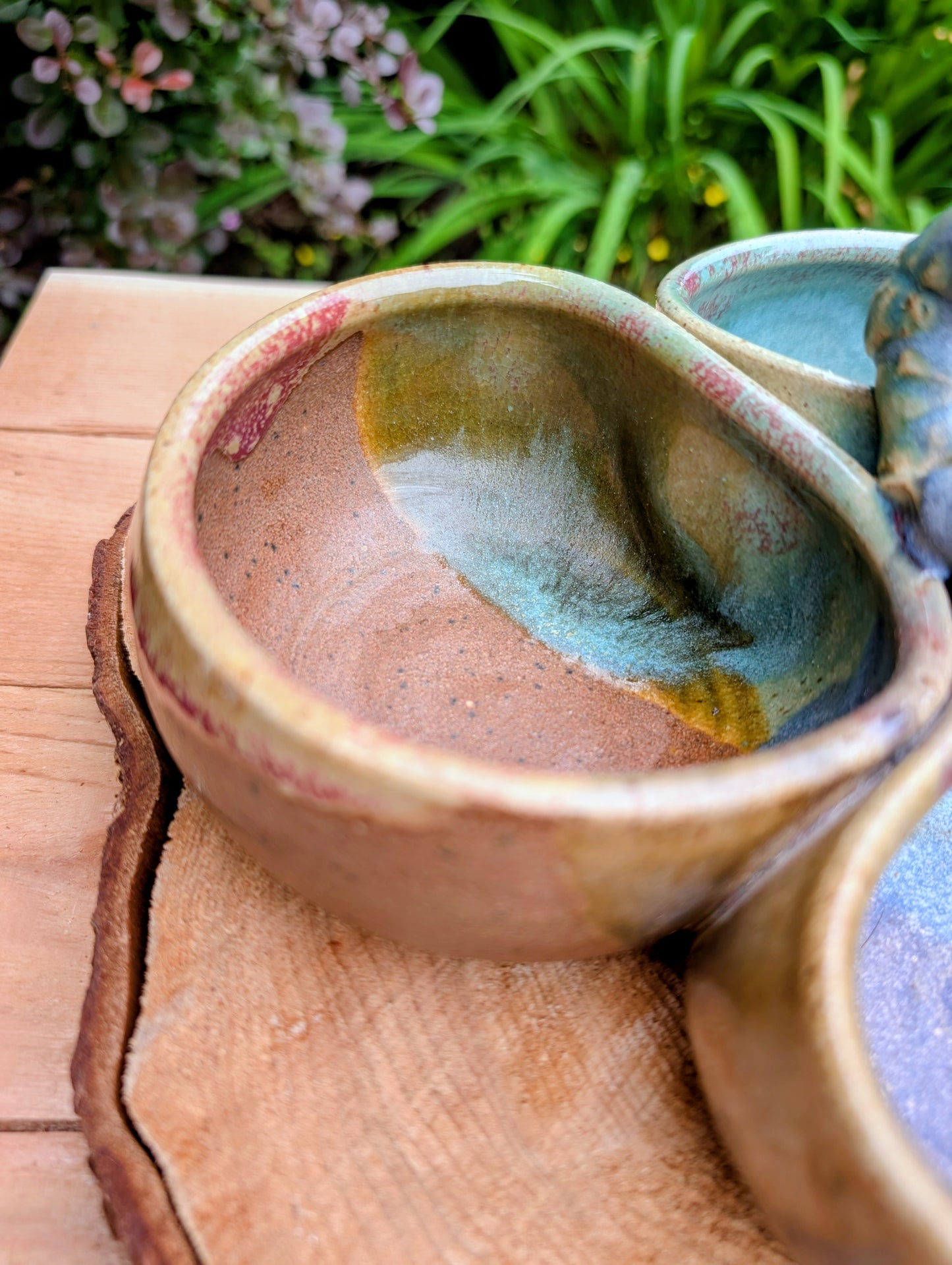Beautifully handcrafted and artist signed, this three-bowl stoneware condiment server combines sculptural artistry with everyday functionality. Finished in layered seafoam, aqua, moss, and earthy glazes, it brings timeless craftsmanship and Pacific Northwest-inspired beauty to entertaining.