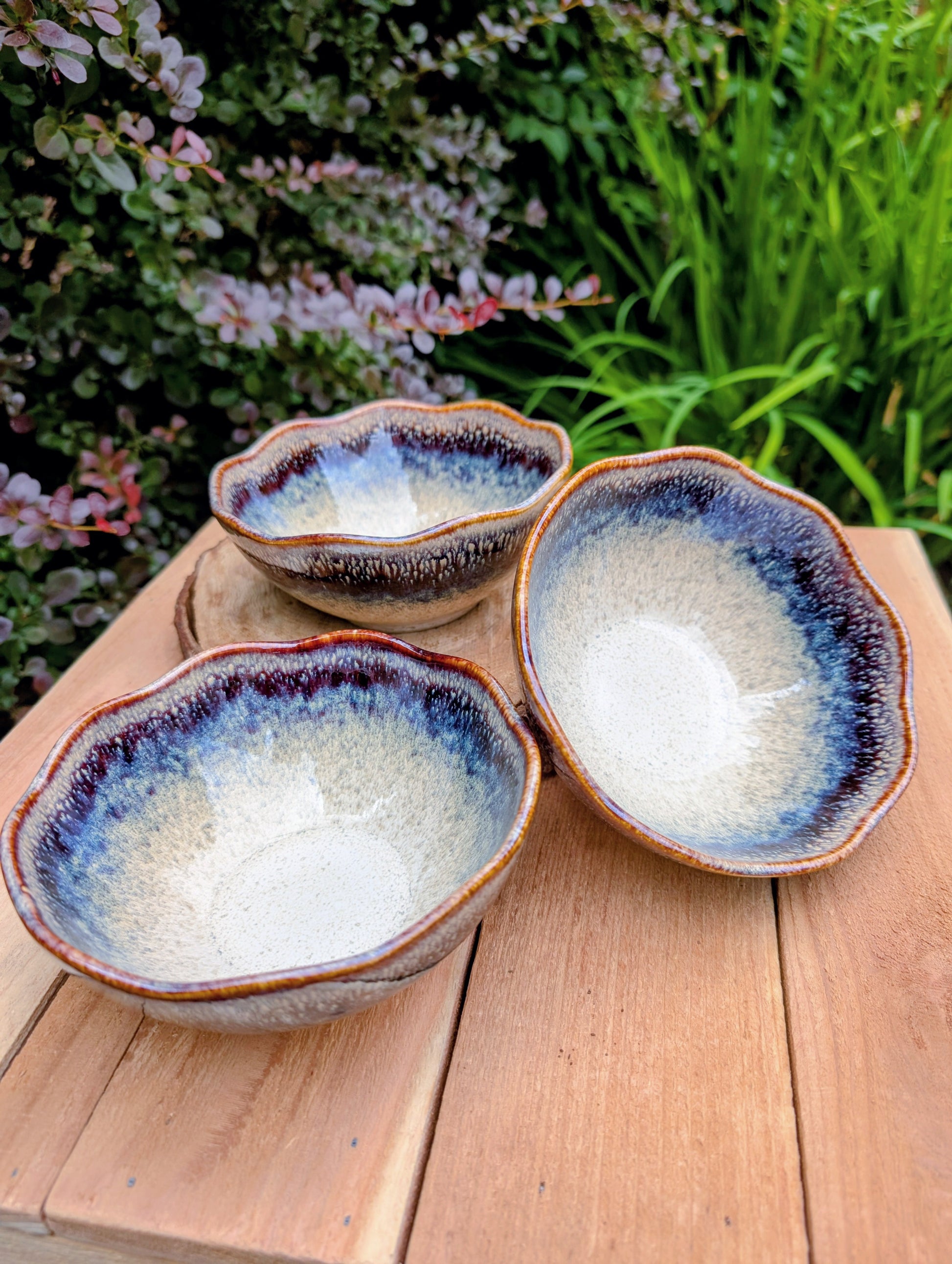 Bring understated elegance to everyday dining with this set of three RIRAKU stackable stoneware bowls. Featuring organically scalloped rims and beautifully layered reactive glazes inspired by traditional Japanese pottery, these versatile bowls are perfect for soups, rice, snacks, desserts, and small shared dishes.