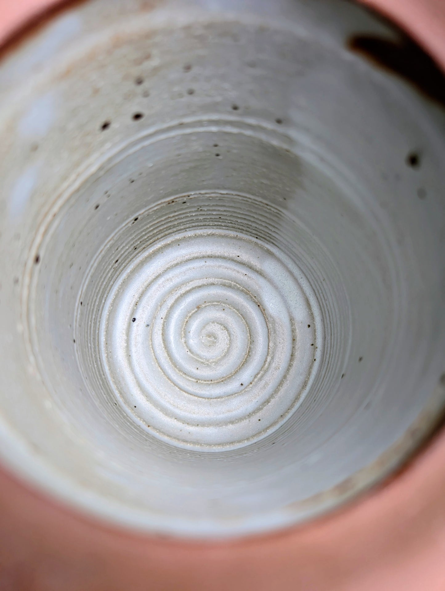 Bring warmth and handcrafted character to your kitchen with this wheel-thrown stoneware canister. Finished in a soft creamy-white glaze with subtle iron speckling, this timeless storage vessel blends rustic craftsmanship with modern organic design.