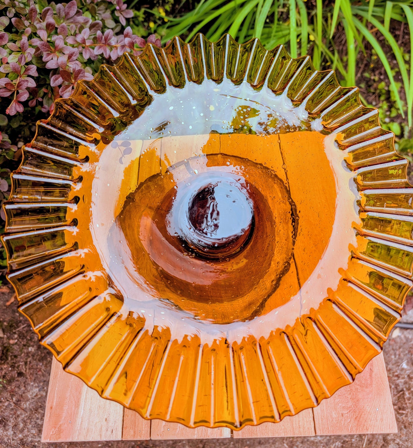 Bring warm vintage charm to your home with this large amber pressed glass pedestal console bowl, estimated to have been made by Indiana Glass during the 1960s–1970s. Its dramatic ruffled rim and generous size make it a beautiful centerpiece for seasonal displays, fruit, florals, or decorative accents throughout the year.
