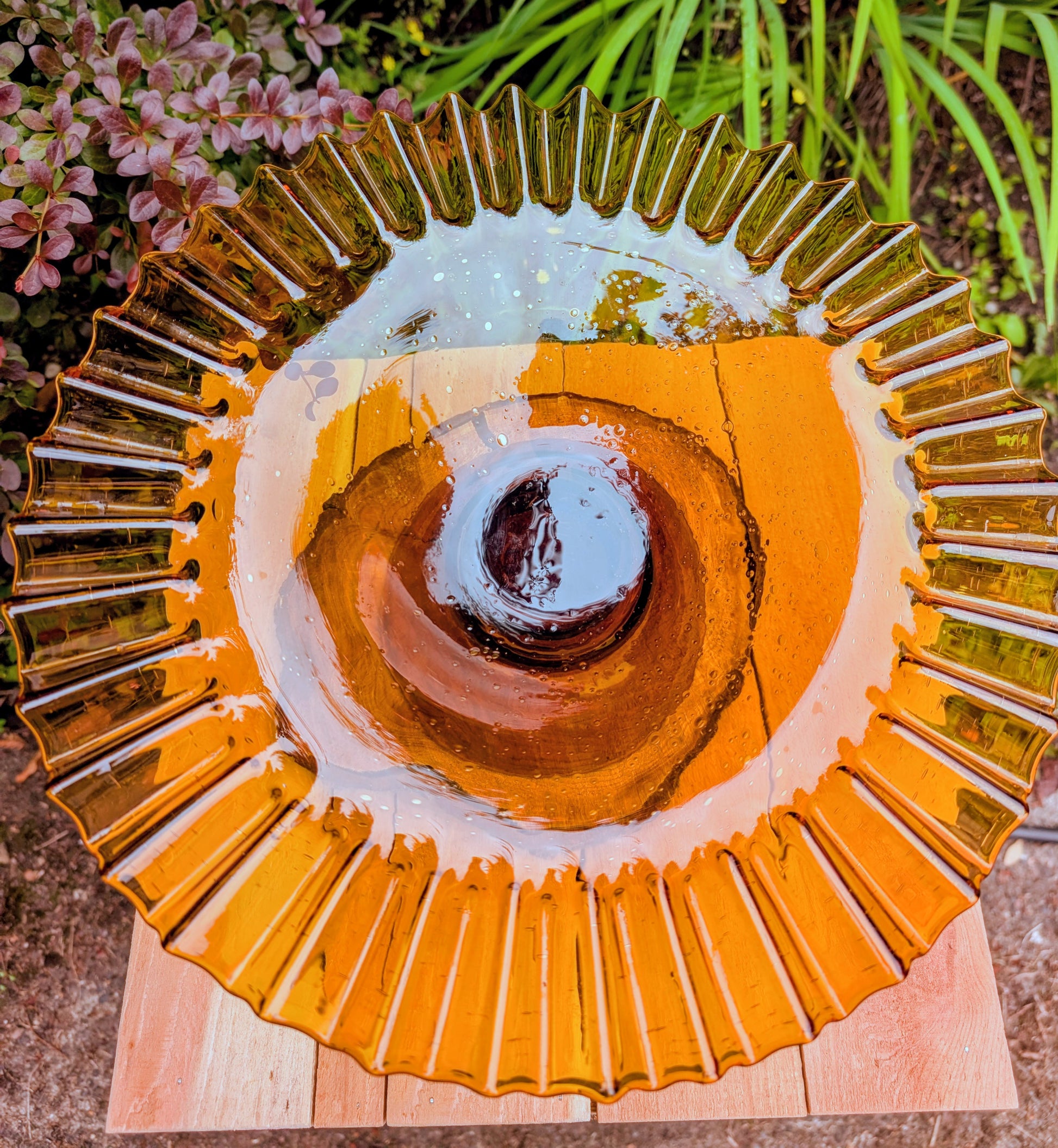 Bring warm vintage charm to your home with this large amber pressed glass pedestal console bowl, estimated to have been made by Indiana Glass during the 1960s–1970s. Its dramatic ruffled rim and generous size make it a beautiful centerpiece for seasonal displays, fruit, florals, or decorative accents throughout the year.