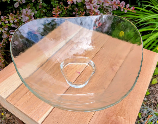 Bring sculptural elegance to your home or garden with this large freeform clear art glass bowl. Its organic silhouette, textured surface, and versatile design make it equally beautiful as a centerpiece, floating candle bowl, or decorative bird bath.
