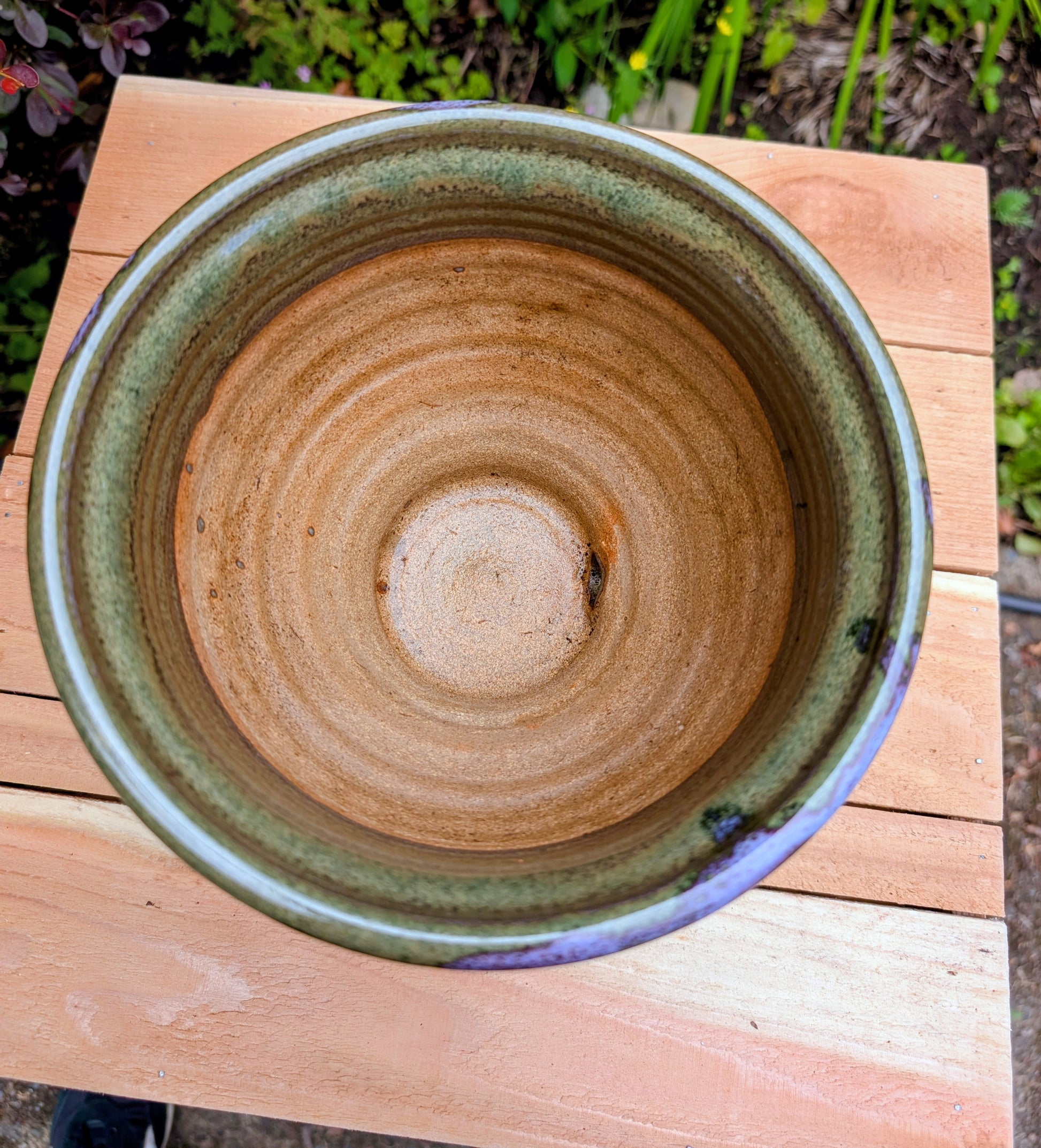 Handcrafted in Snohomish, Washington, this authentic Bruning Pottery stoneware planter showcases flowing moss green, olive, brown, and plum glazes inspired by the Pacific Northwest landscape. Complete with an integrated saucer, it's a beautiful and functional piece for houseplants, herbs, or succulent collections.