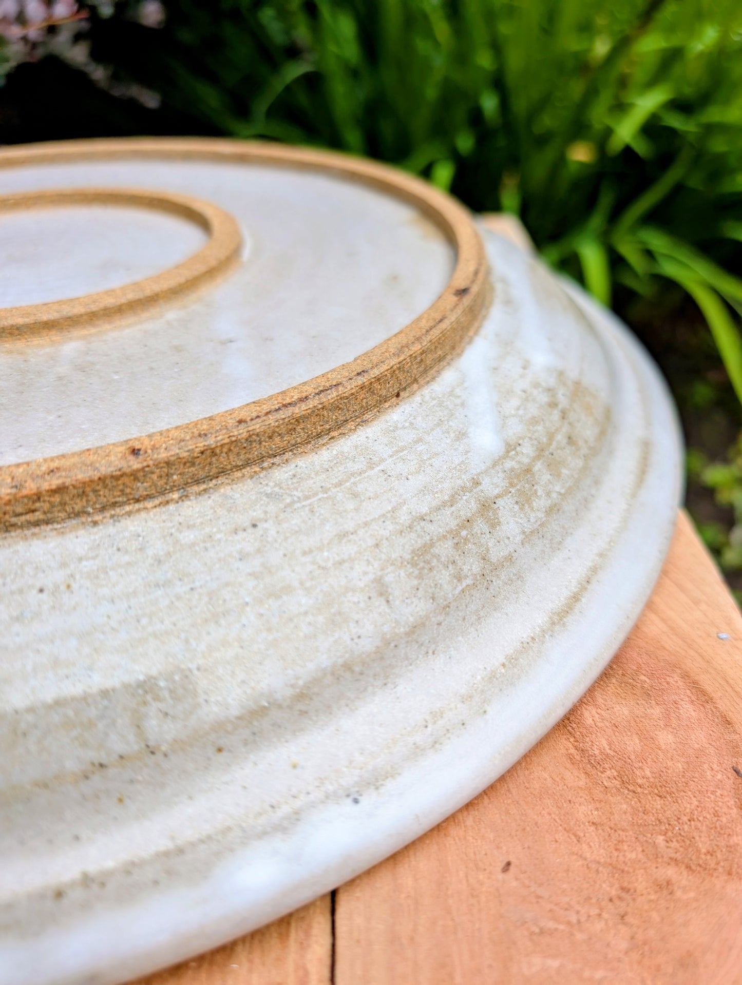 A beautifully hand-thrown studio pottery platter featuring expressive blue-gray and olive brushwork over a soft neutral glaze. Its generous size and timeless craftsmanship make it equally suited for serving, display, or as striking wall décor.