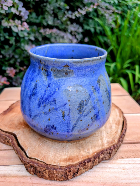 Handcrafted and artist-signed, this wheel-thrown stoneware vessel features a rich satin matte cobalt blue glaze accented with natural iron speckling. Originally created as a lidded storage jar, it now serves beautifully as a versatile open vessel for display or everyday use.