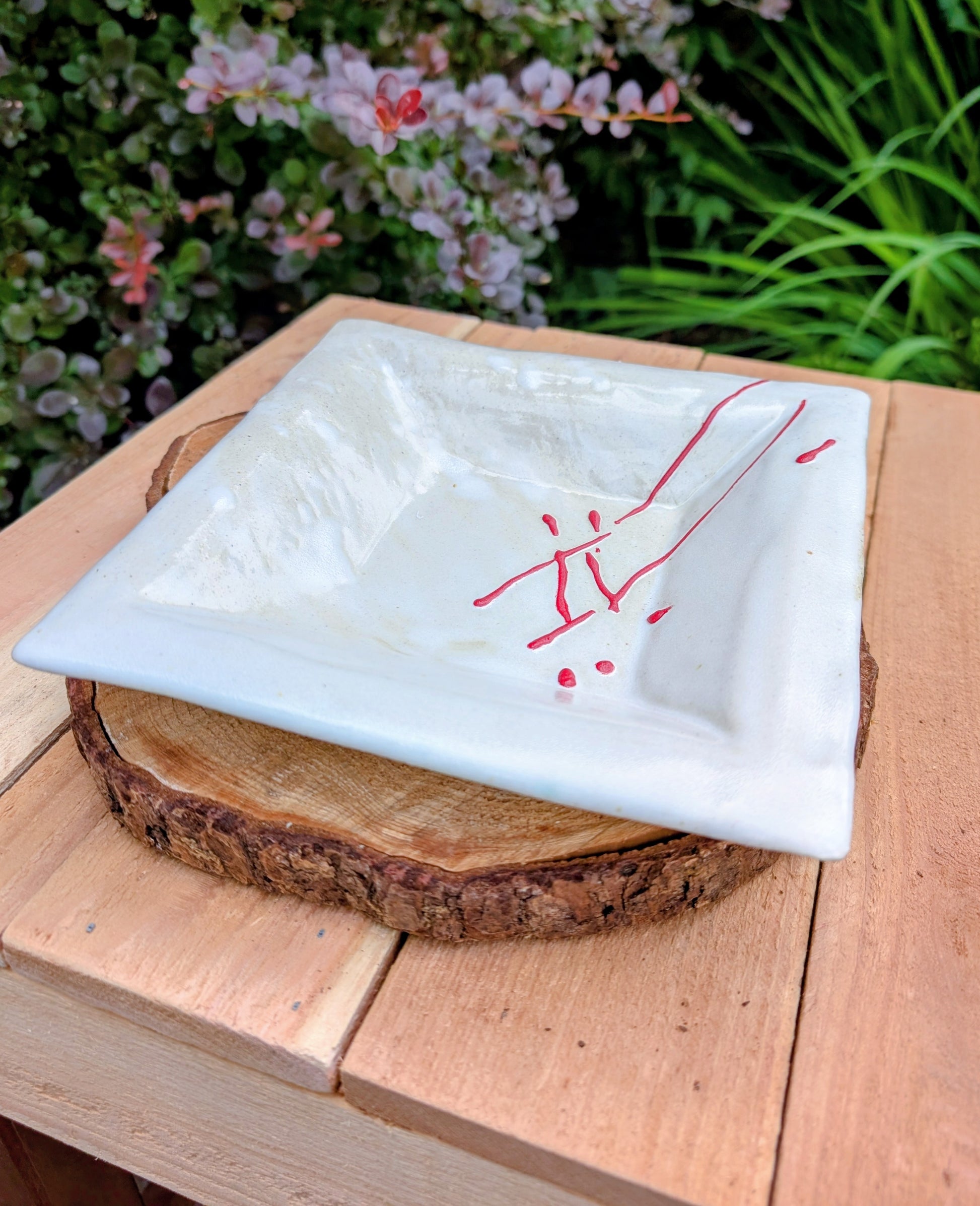 Bring handcrafted artistry into your home with this unsigned studio pottery catchall dish featuring a sculptural folded-corner design and expressive red slip decoration. Beautiful as both functional pottery and contemporary décor, it offers timeless Pacific Northwest style with organic modern appeal.