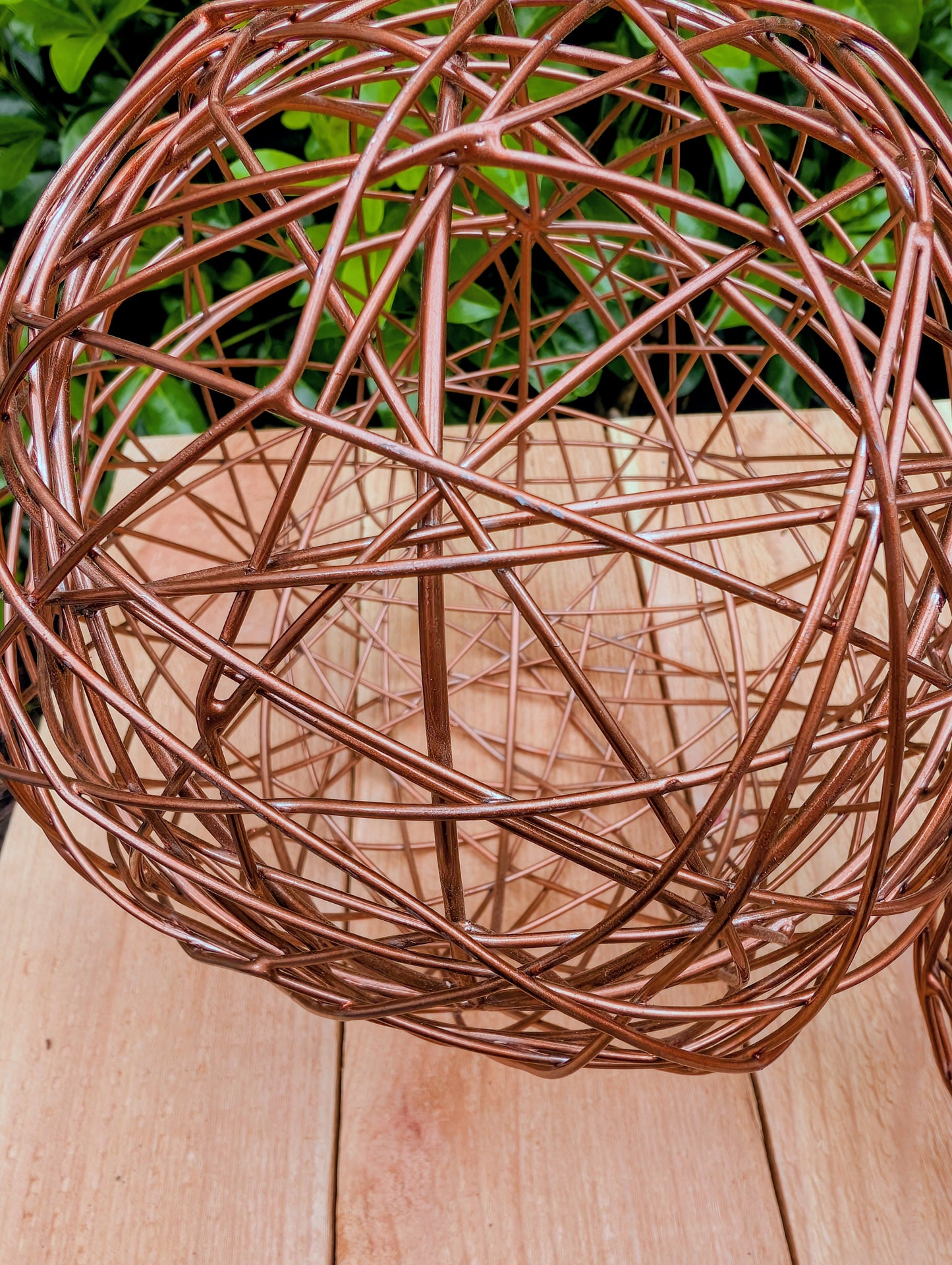 Bring warmth and texture to your home with this coordinated set of two copper-tone woven metal decorative spheres. Their sculptural open-weave design complements modern organic, farmhouse, industrial, and contemporary interiors, making them versatile accents for shelves, coffee tables, decorative bowls, and centerpieces.