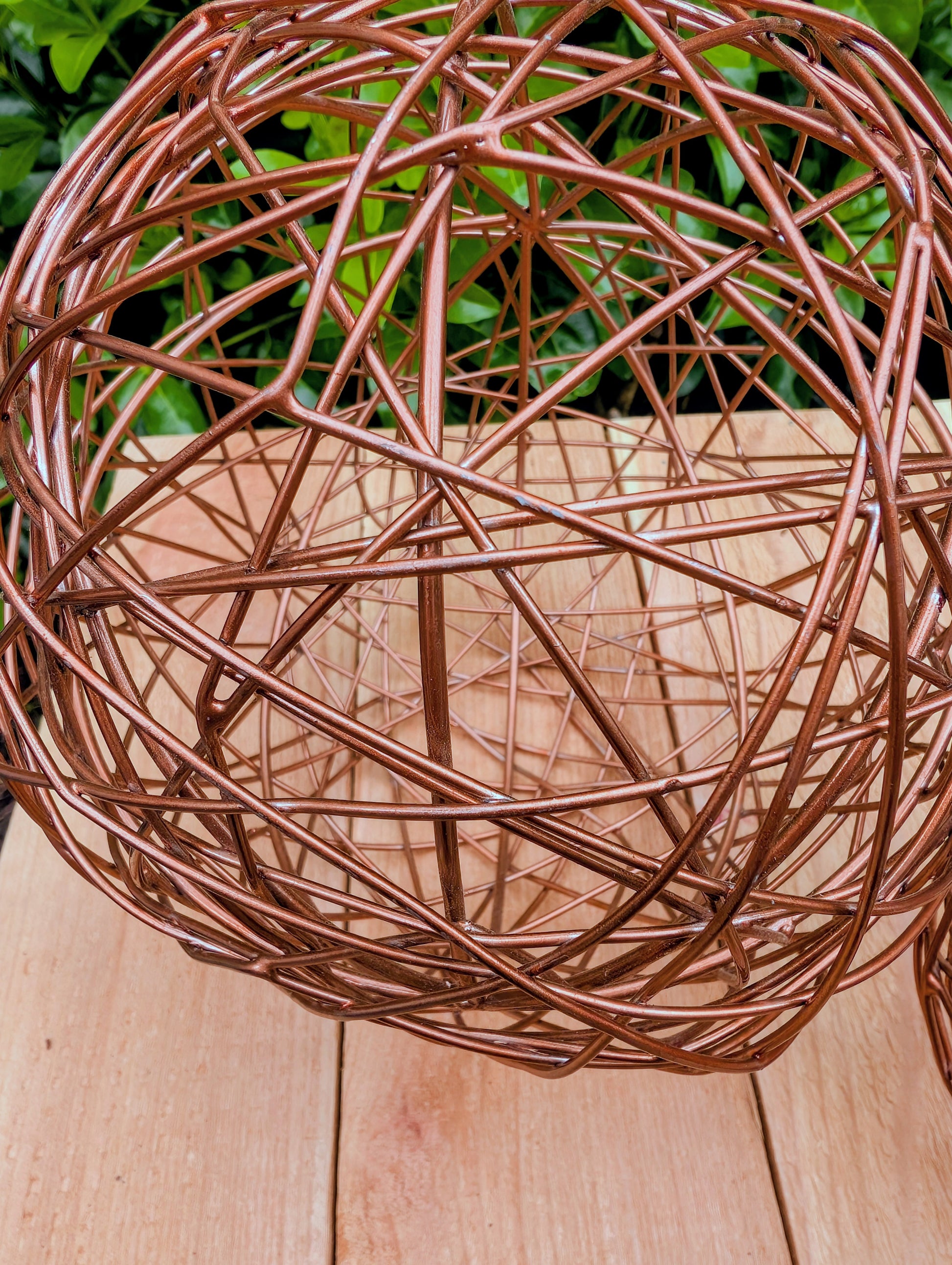 Bring warmth and texture to your home with this coordinated set of two copper-tone woven metal decorative spheres. Their sculptural open-weave design complements modern organic, farmhouse, industrial, and contemporary interiors, making them versatile accents for shelves, coffee tables, decorative bowls, and centerpieces.