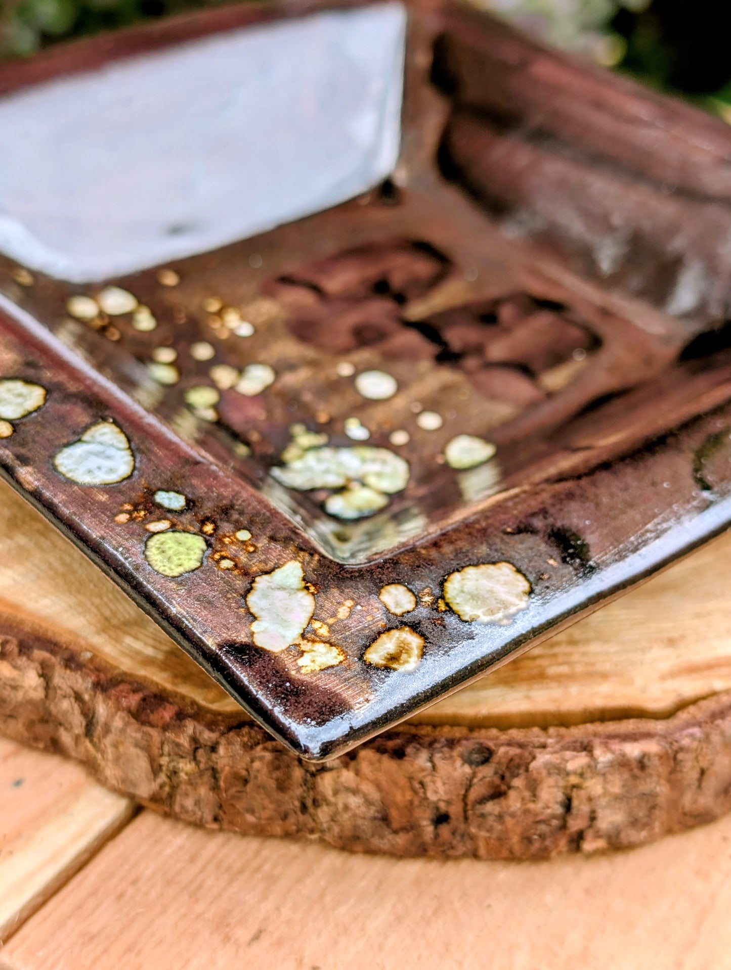 Celebrate the beauty of handcrafted ceramics with this square studio pottery dish featuring layered reactive glazes in rich chocolate brown, gray, olive, cream, and golden crystalline accents. Perfect as a catchall tray, jewelry dish, appetizer plate, or decorative accent, it brings organic warmth to any space.