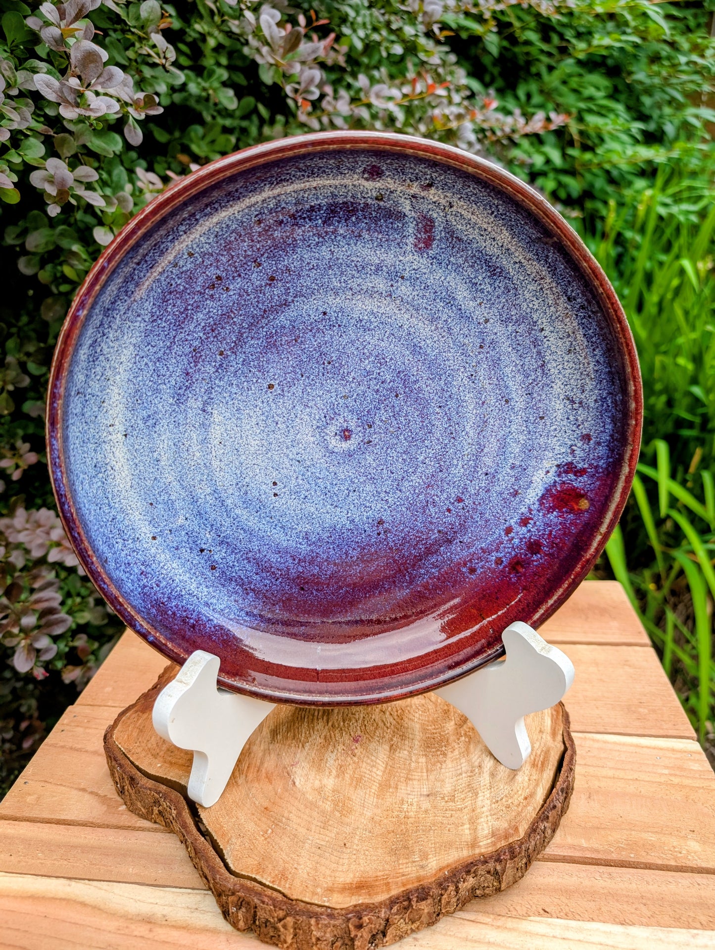 A beautifully hand-thrown studio pottery serving bowl signed and dated 1991, featuring a richly layered cobalt blue interior and deep oxblood exterior glaze. Whether used for serving or displayed as functional art, this handcrafted stoneware piece showcases the timeless beauty of American studio ceramics.
