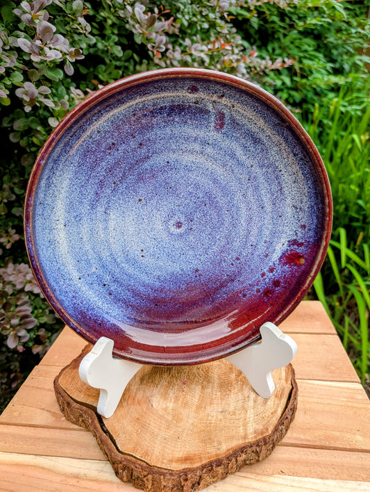 A beautifully hand-thrown studio pottery serving bowl signed and dated 1991, featuring a richly layered cobalt blue interior and deep oxblood exterior glaze. Whether used for serving or displayed as functional art, this handcrafted stoneware piece showcases the timeless beauty of American studio ceramics.