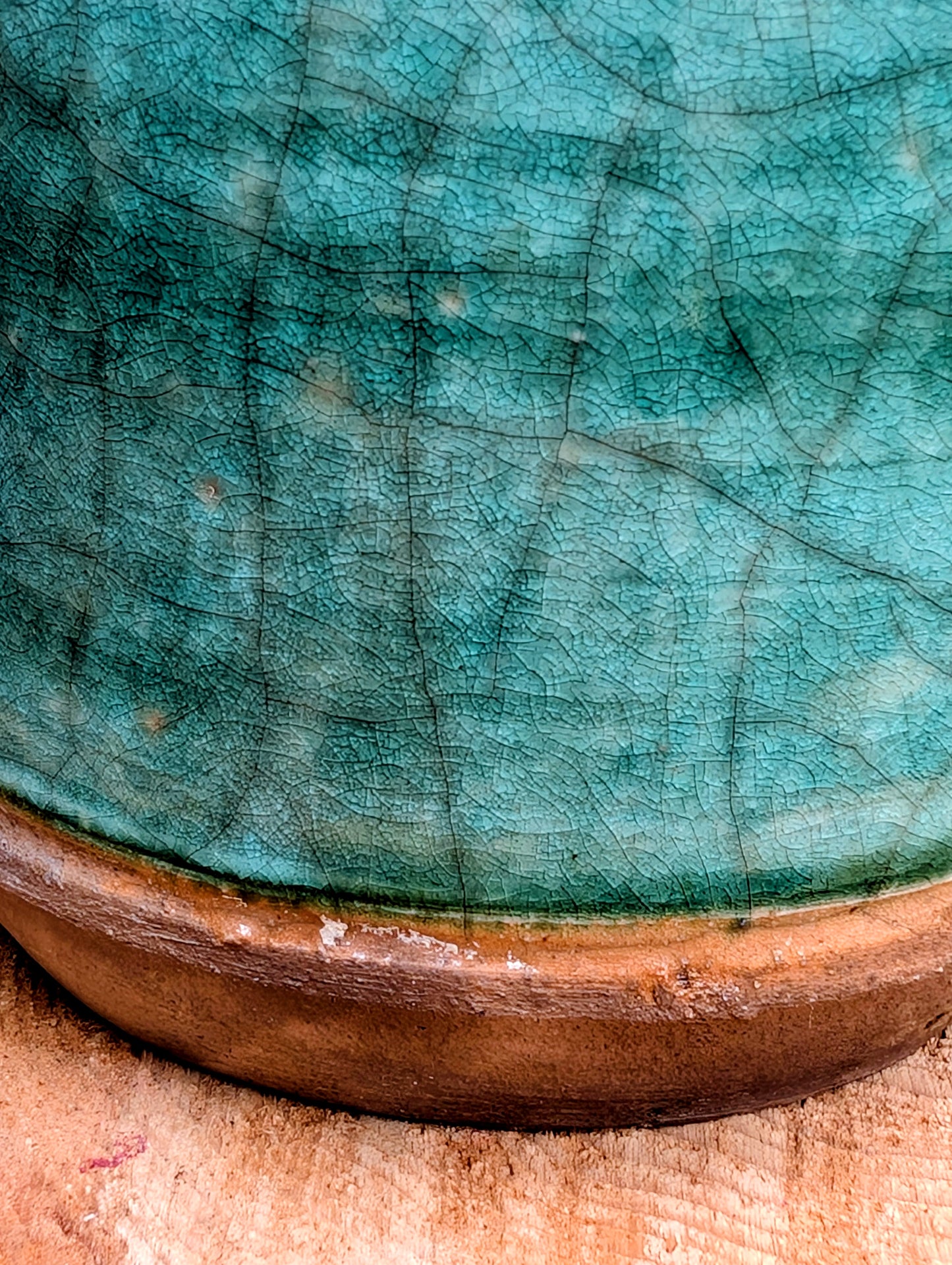 Celebrate the artistry of 1970s studio ceramics with this signed and dated handmade stoneware vase. Finished in a rich teal crackle glaze with distinctive white applied slip decoration, this sculptural piece brings timeless character to shelves, tables, and curated collections.