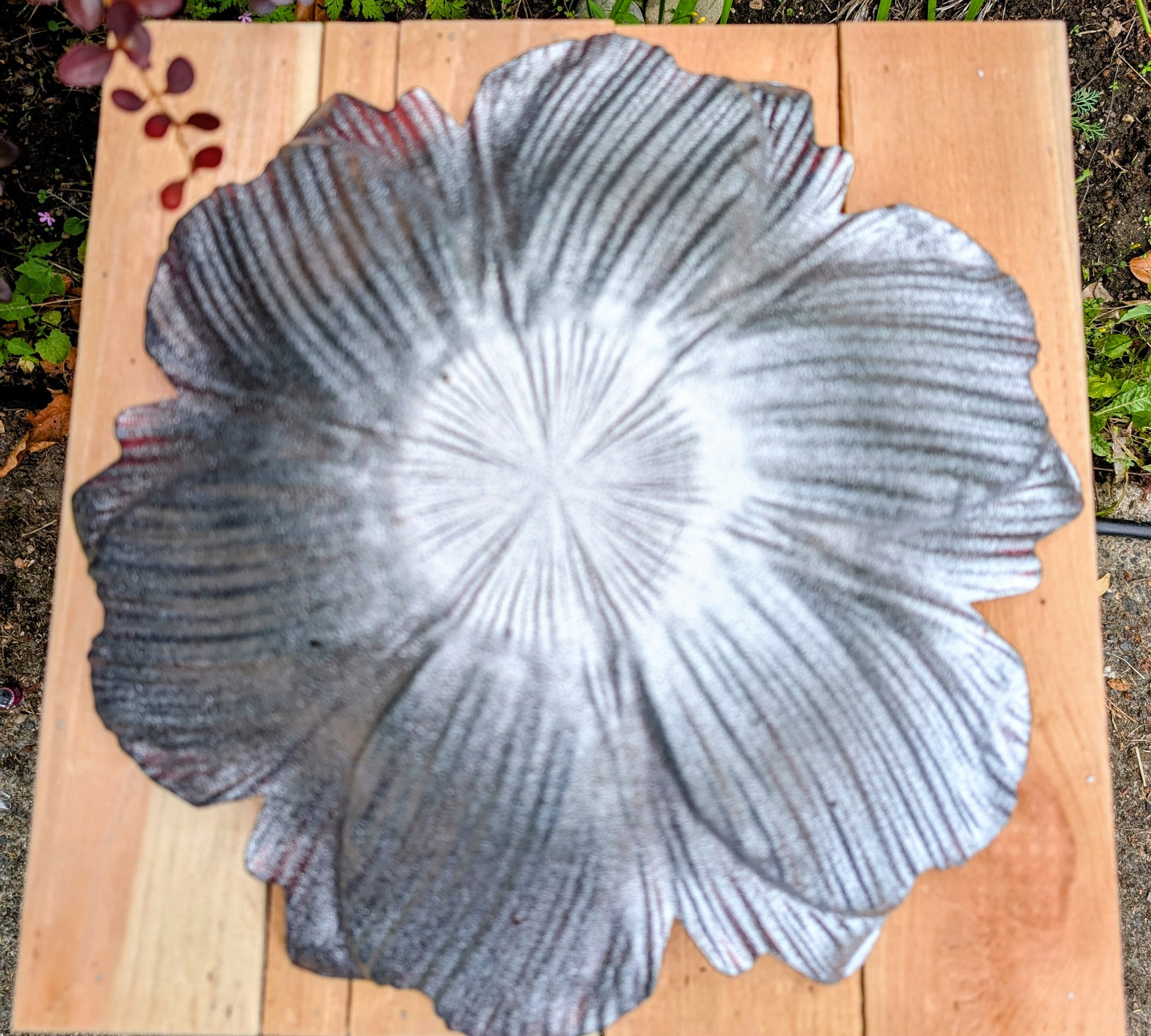 Bring color and artistry to your home or garden with this iridescent art glass floral bowl. Featuring shimmering purple and blue hues, it serves beautifully as either a striking tabletop centerpiece or a decorative bird bath bowl.
