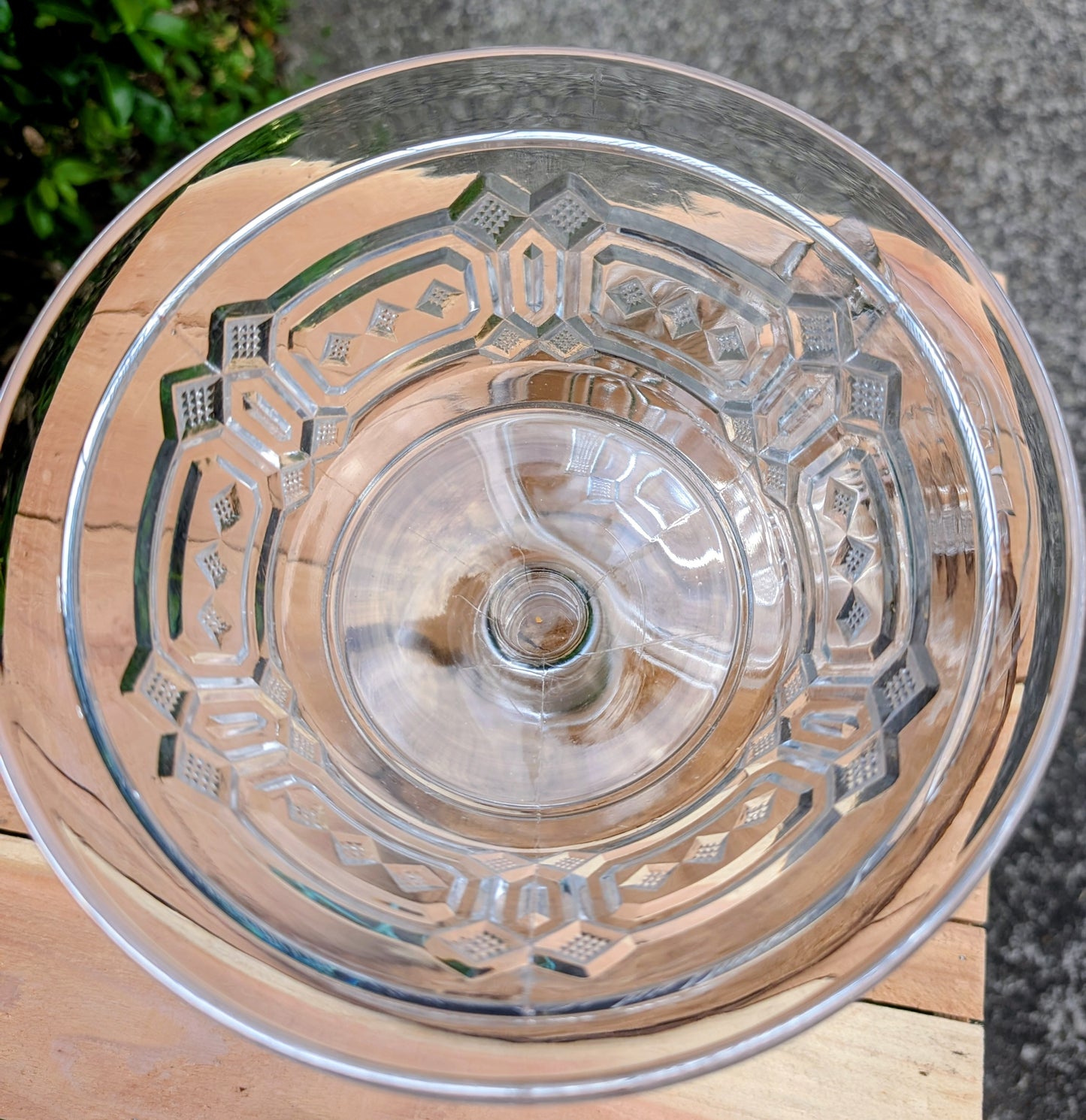An elegant early 20th-century pressed glass covered compote featuring bold geometric Art Deco styling and a striking pedestal silhouette. Although the pedestal has visible stress cracks, the original lid, impressive scale, and architectural design make it a beautiful decorative display piece.
