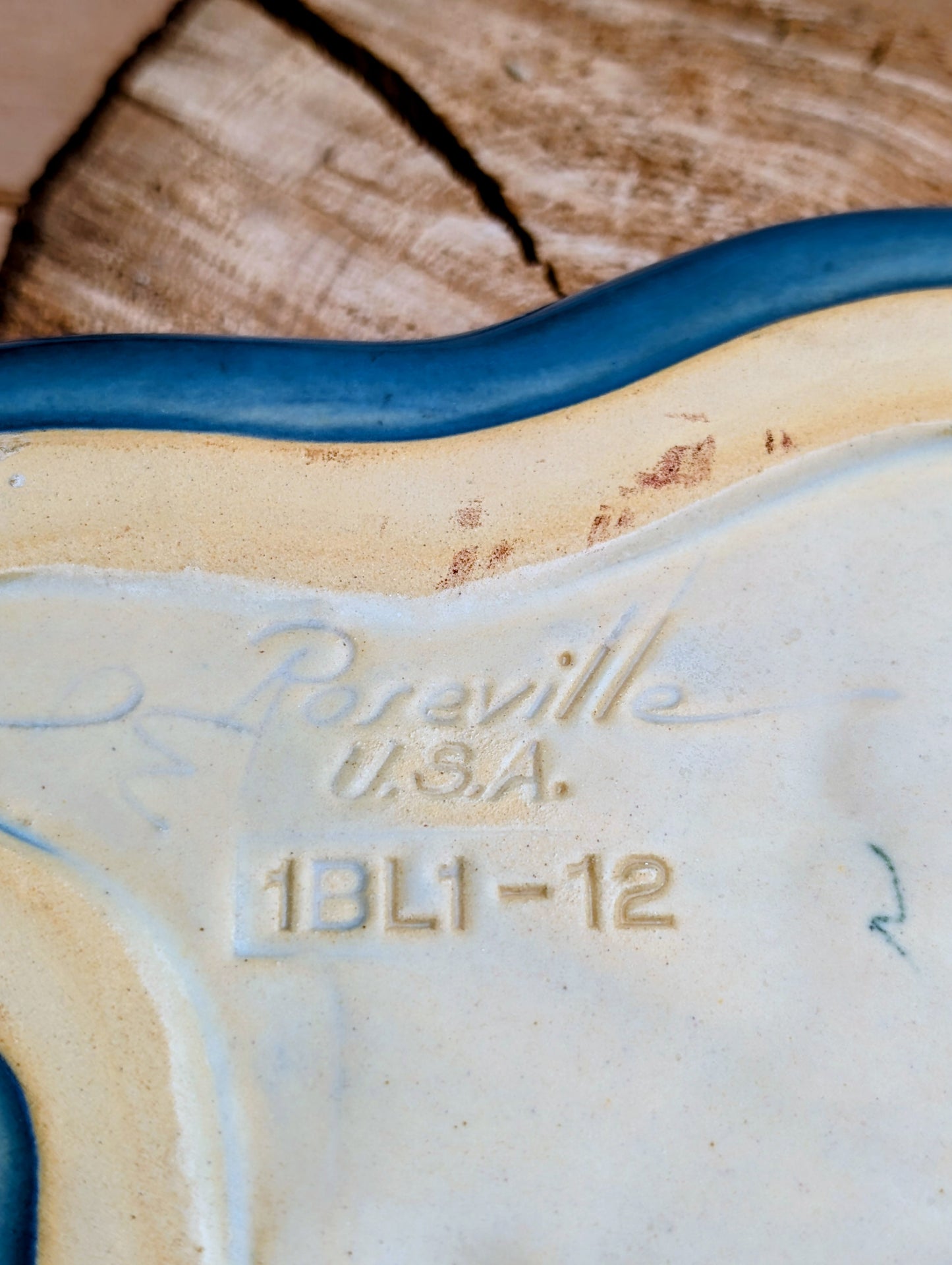 Close-up of the underside of a ceramic plate or dish, showing embossed text reading 'Poreville U.S.