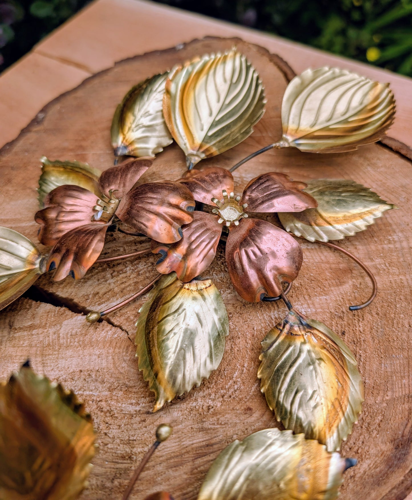 Bring the warmth of 1970s botanical décor into your home with this charming pair of vintage brass and copper-tone dogwood wall sculptures. Their delicate floral design and mixed-metal finish make them an easy addition to Mid-Century Modern, cottage, and nature-inspired interiors.