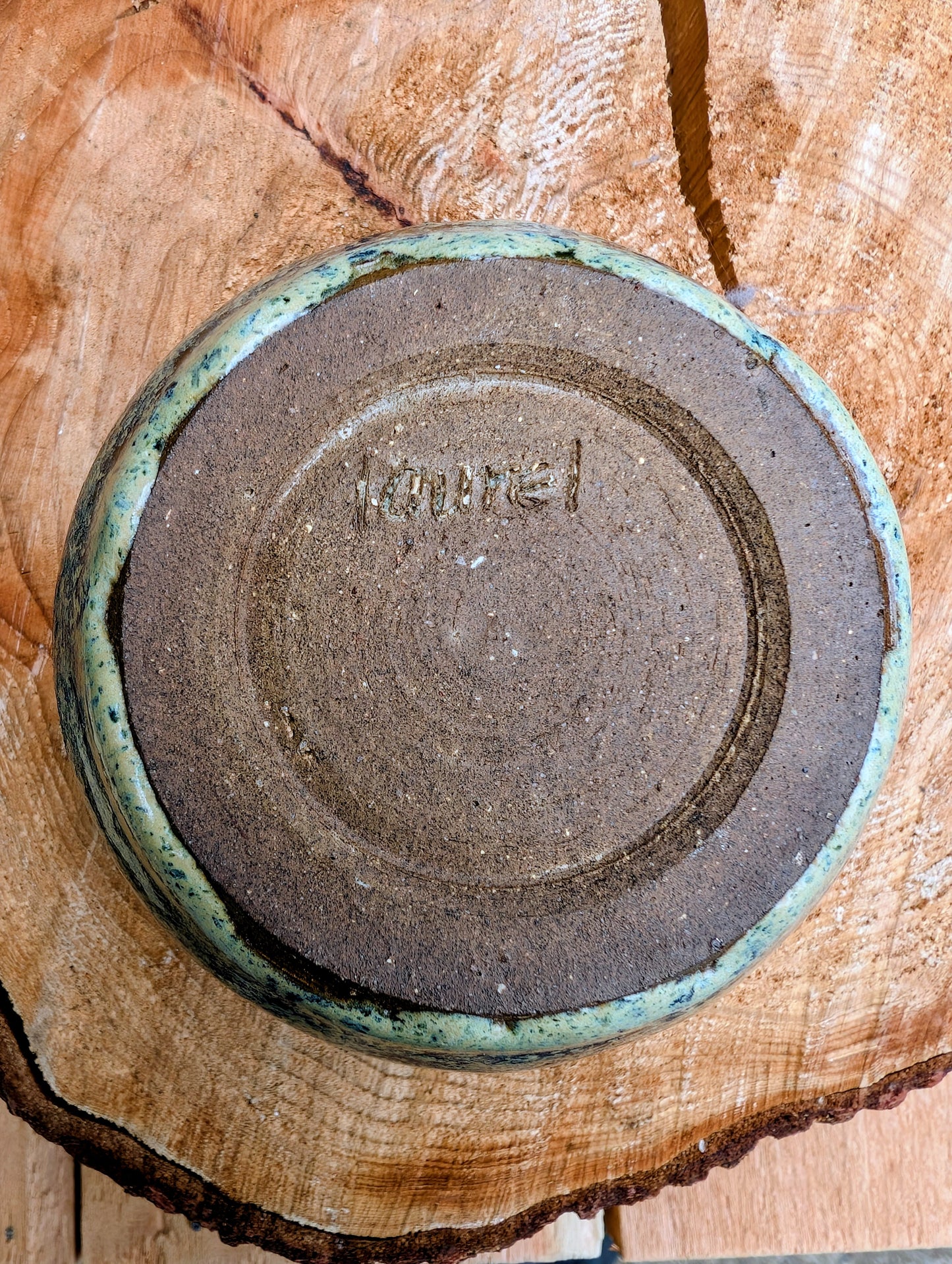 A beautifully hand-thrown studio pottery bowl featuring a rich olive green interior and layered blue, cream, and earthy brown glaze. Signed by the artist, this compact stoneware piece blends functional craftsmanship with timeless Pacific Northwest style.
