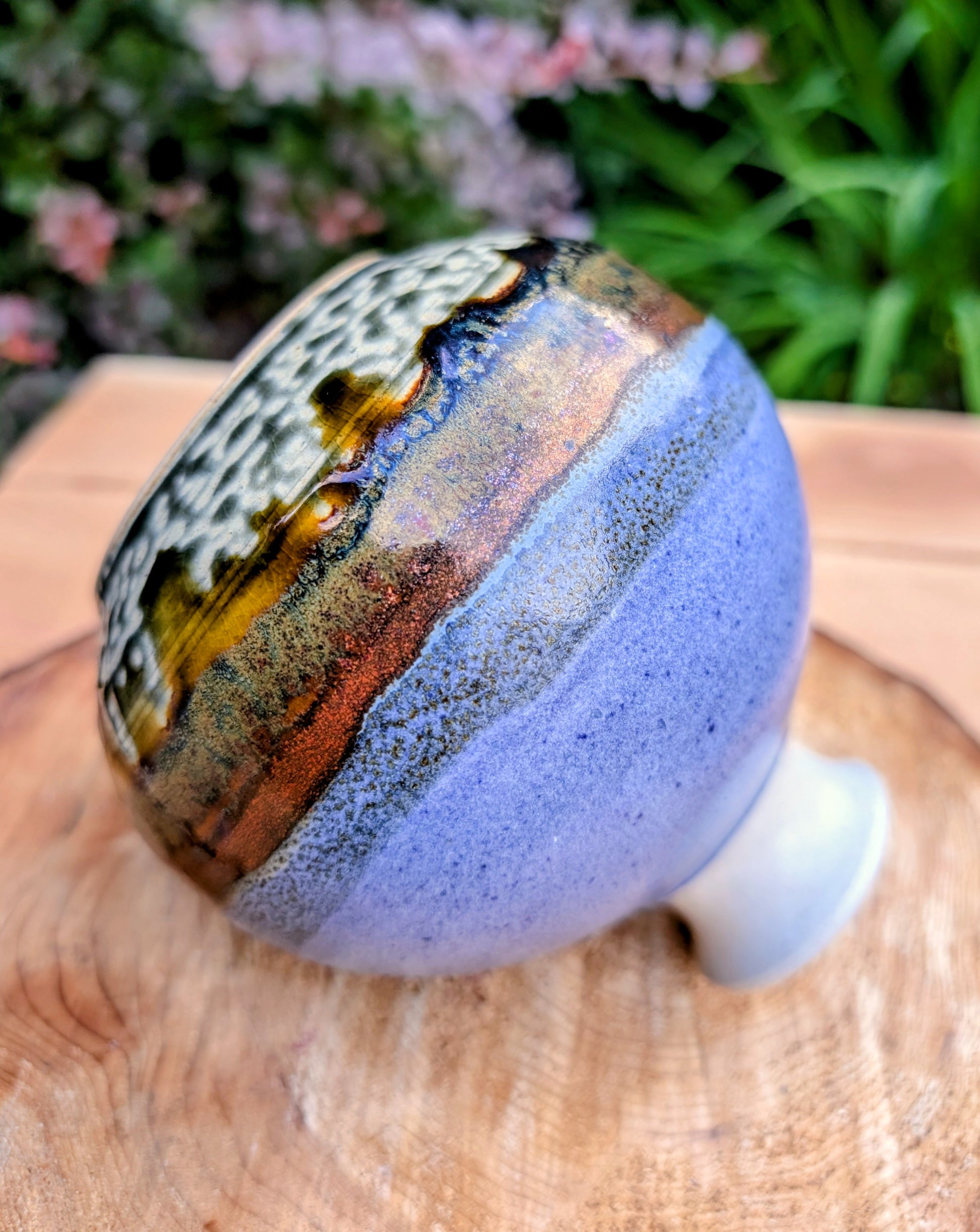 A beautifully signed studio pottery bud vase featuring a softly rounded bubble form and layered landscape-inspired glazes. Its organic silhouette and calming palette make it an elegant accent for modern, minimalist, and nature-inspired interiors.