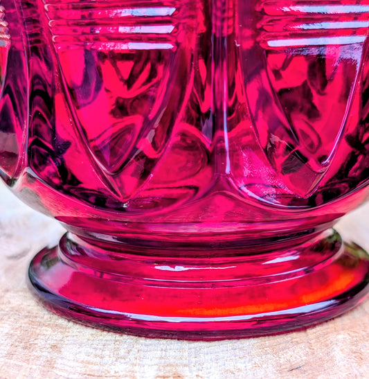 Add timeless elegance to your home with this authentic 1980s Fenton Ruby Red Barred Teardrop Covered Candy Dish. Rich jewel-toned pressed glass, exceptional craftsmanship, and the verified 1980s Fenton maker's mark make this a beautiful display piece for collectors and vintage décor enthusiasts alike.
