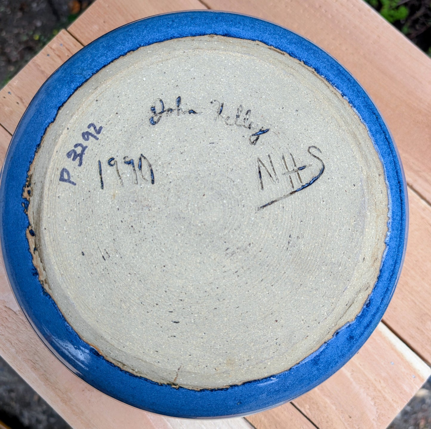 A beautifully hand-thrown studio pottery bowl dated 1990, featuring a rich satin cobalt blue glaze with a subtle spiral movement across the interior. Signed by the artist (maker currently unconfirmed), this functional stoneware piece blends everyday usefulness with timeless handcrafted artistry.