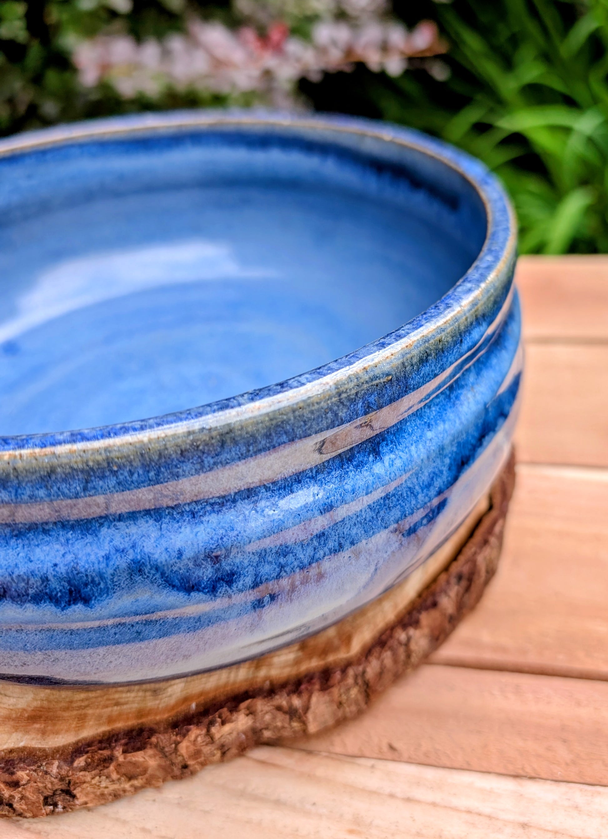 A beautifully hand-thrown studio pottery bowl dated 1990, featuring a rich satin cobalt blue glaze with a subtle spiral movement across the interior. Signed by the artist (maker currently unconfirmed), this functional stoneware piece blends everyday usefulness with timeless handcrafted artistry.