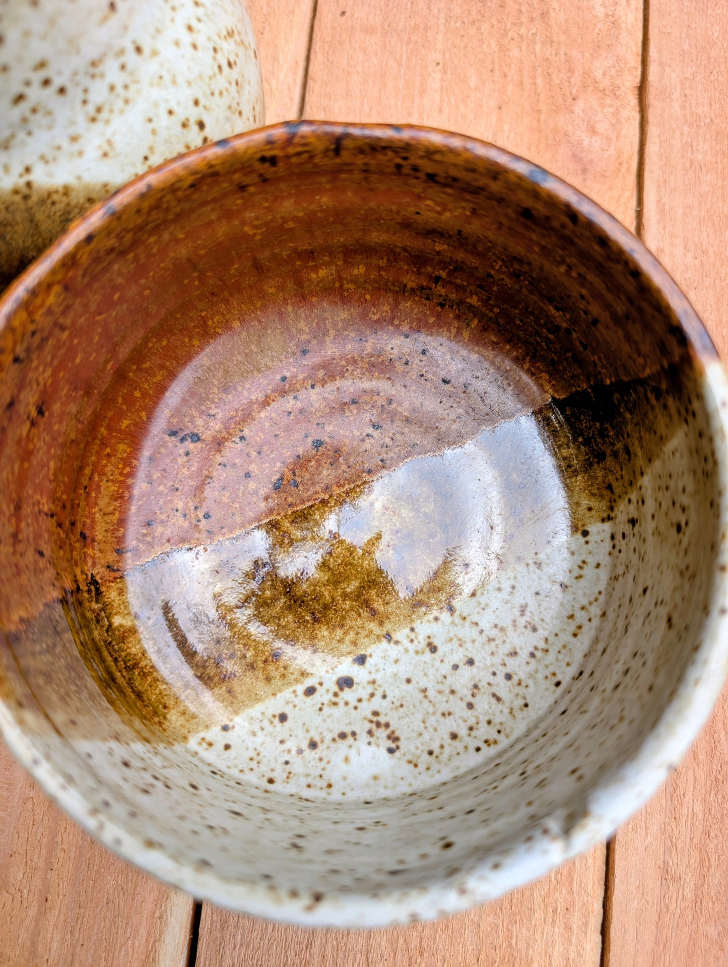 Bring handcrafted warmth to your table with this signed studio pottery creamer and sugar bowl set. Finished in a beautiful speckled cream glaze with flowing olive-brown accents, this artisan stoneware pair blends rustic craftsmanship with timeless everyday function.