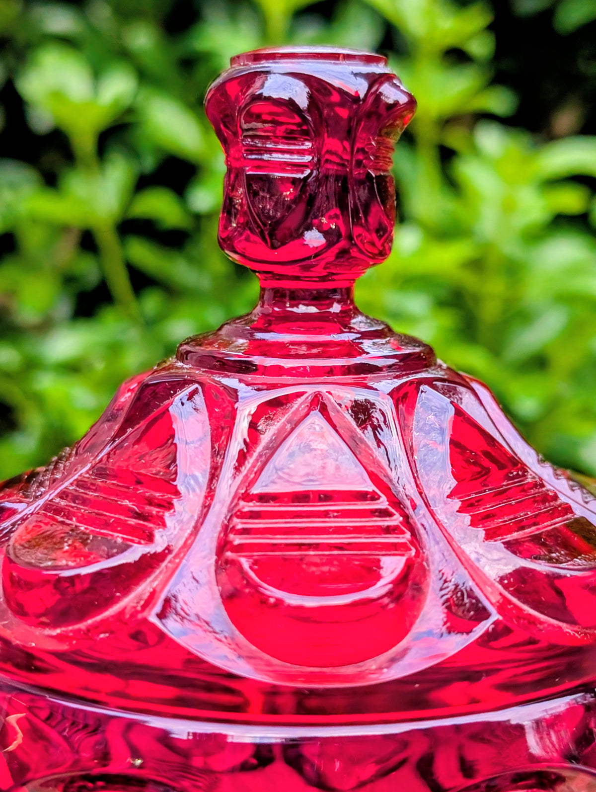 Add timeless elegance to your home with this authentic 1980s Fenton Ruby Red Barred Teardrop Covered Candy Dish. Rich jewel-toned pressed glass, exceptional craftsmanship, and the verified 1980s Fenton maker's mark make this a beautiful display piece for collectors and vintage décor enthusiasts alike.