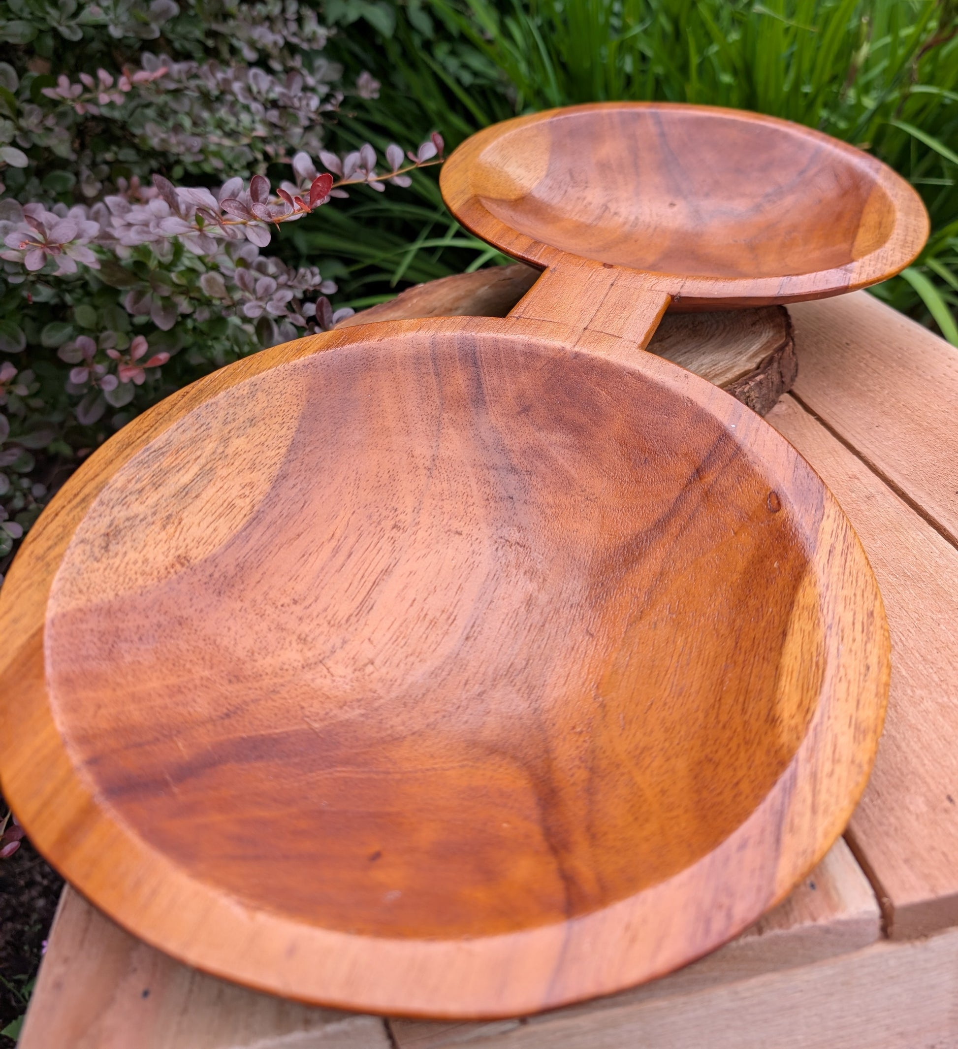 Serve with timeless style using this hand-carved Monkey Pod wood double serving tray. Crafted from a single piece of richly grained hardwood, its sculptural silhouette makes it equally beautiful as a serving piece or decorative centerpiece.