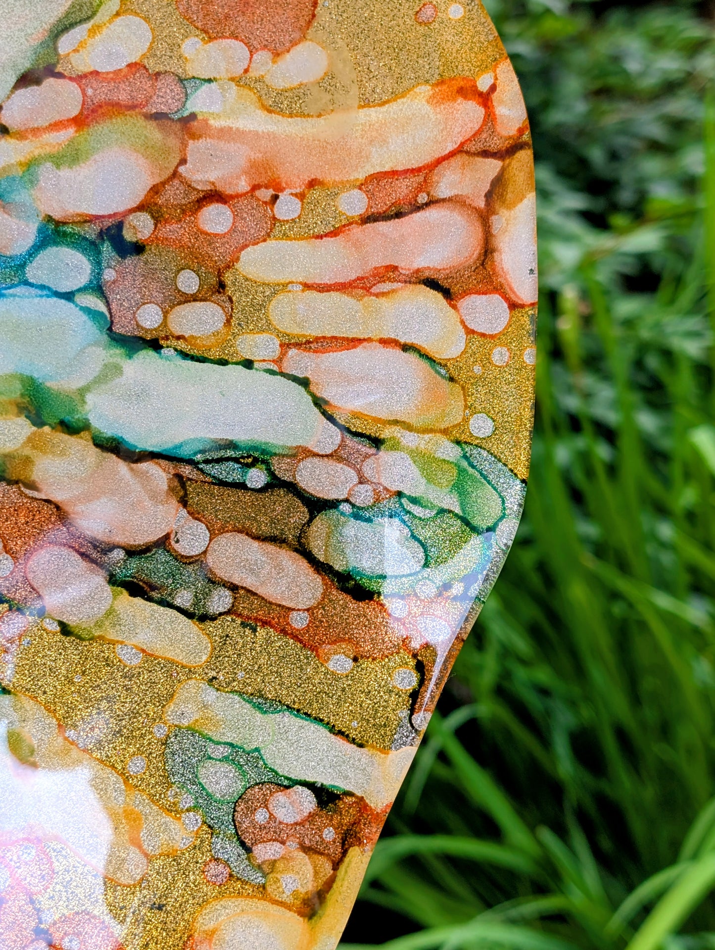 Bring color and light to your home or garden with this contemporary scalloped art glass bowl. Featuring warm golden tones accented by olive green, amber, turquoise, and shimmering metallic highlights, it serves beautifully as a centerpiece, decorative bowl, or tabletop bird bath.