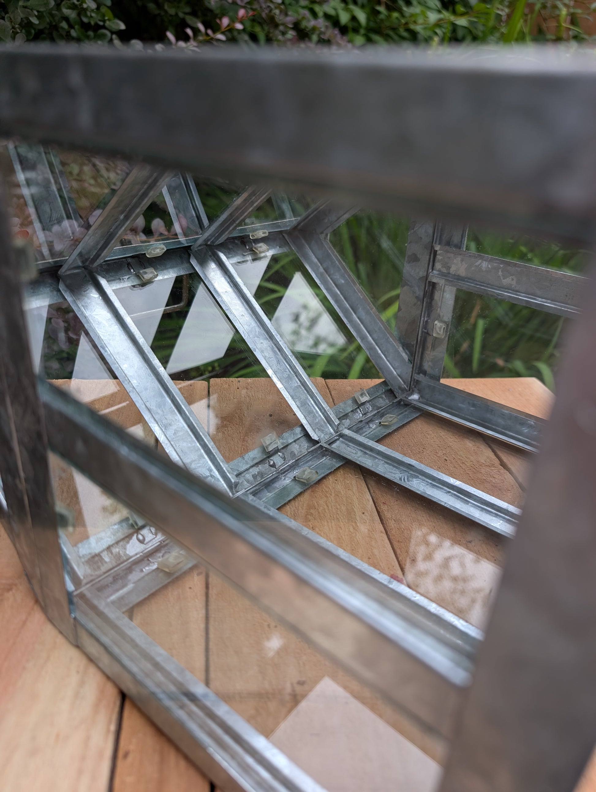 Bring the charm of a Victorian conservatory indoors with this decorative galvanized metal and glass tabletop greenhouse. Perfect for displaying succulents, moss gardens, candles, seasonal décor, or treasured collectibles, it adds timeless botanical style to any room.