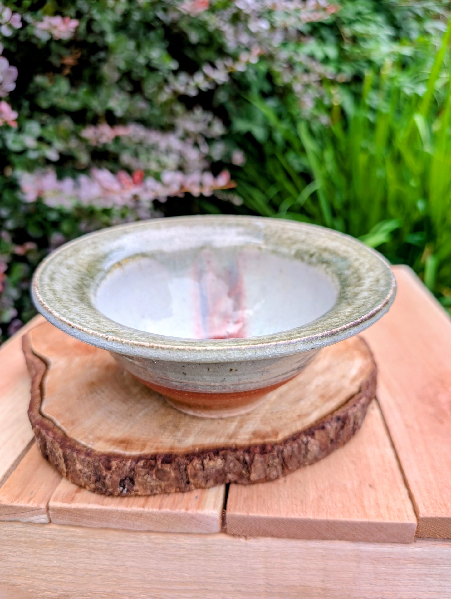 Handcrafted with timeless simplicity, this signed studio pottery serving bowl pairs a soft celadon-gray glaze with a warm iron-rich stoneware body. Its versatile size and understated design make it equally beautiful for serving, display, or everyday living.