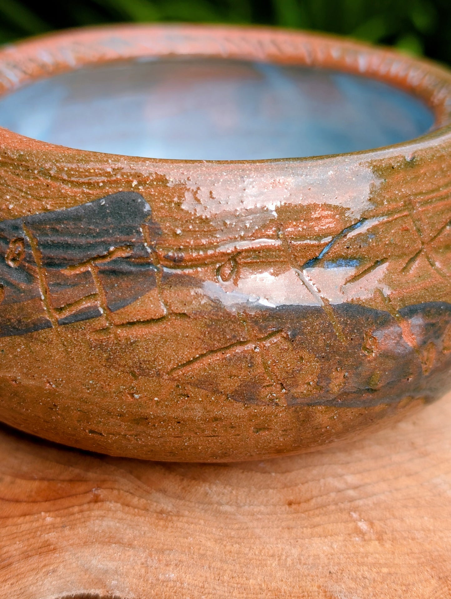 Handcrafted with richly carved texture and a soft blue reactive glaze, this signed studio pottery bowl brings warmth and character to any home. Ideal as a serving bowl, decorative accent, or functional piece of everyday artisan pottery.